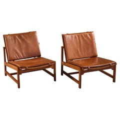 Pair of Arne Karlsen and Peter Hjort Leather and Cane Lounge Chairs