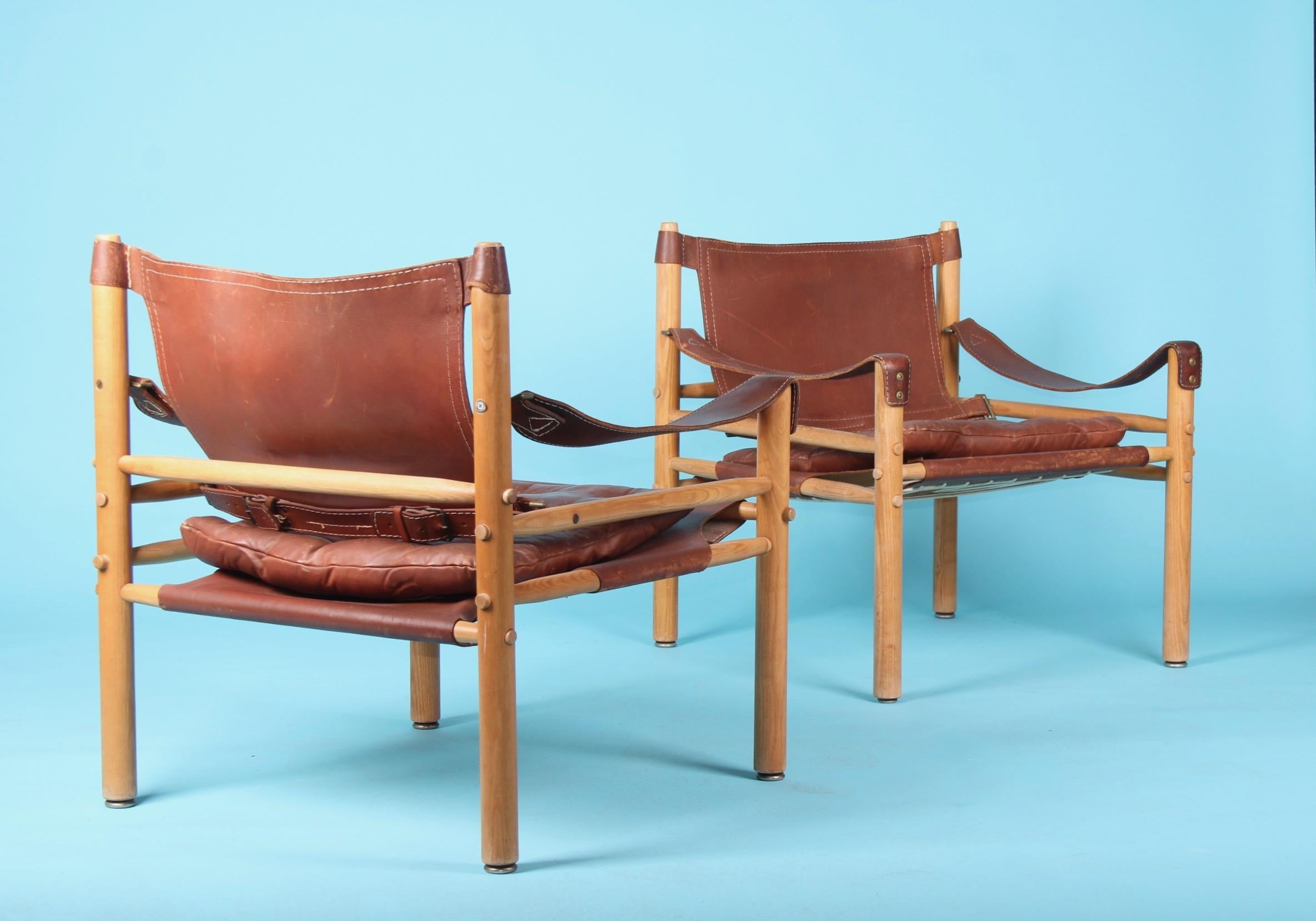 Pair of Arne Norell easy chairs Model Sirocco, 1960s, some scratches on the leather and wear from use.