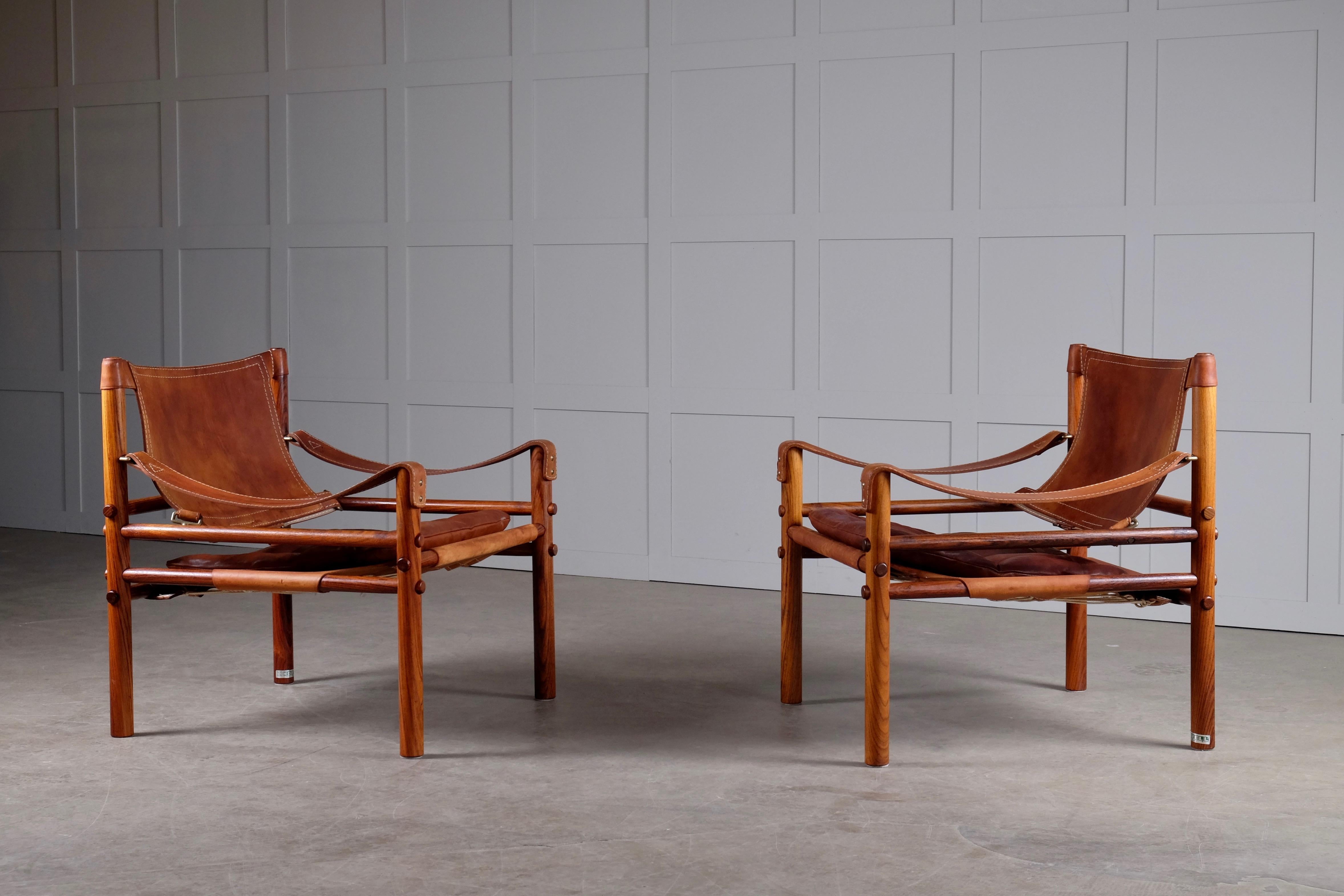 Excellent pair of safari chairs model sirocco in very good condition. Cognac original brown leather.
Designed by Arne Norell, produced by Arne Norell AB in Aneby, Sweden, 1960s.





     