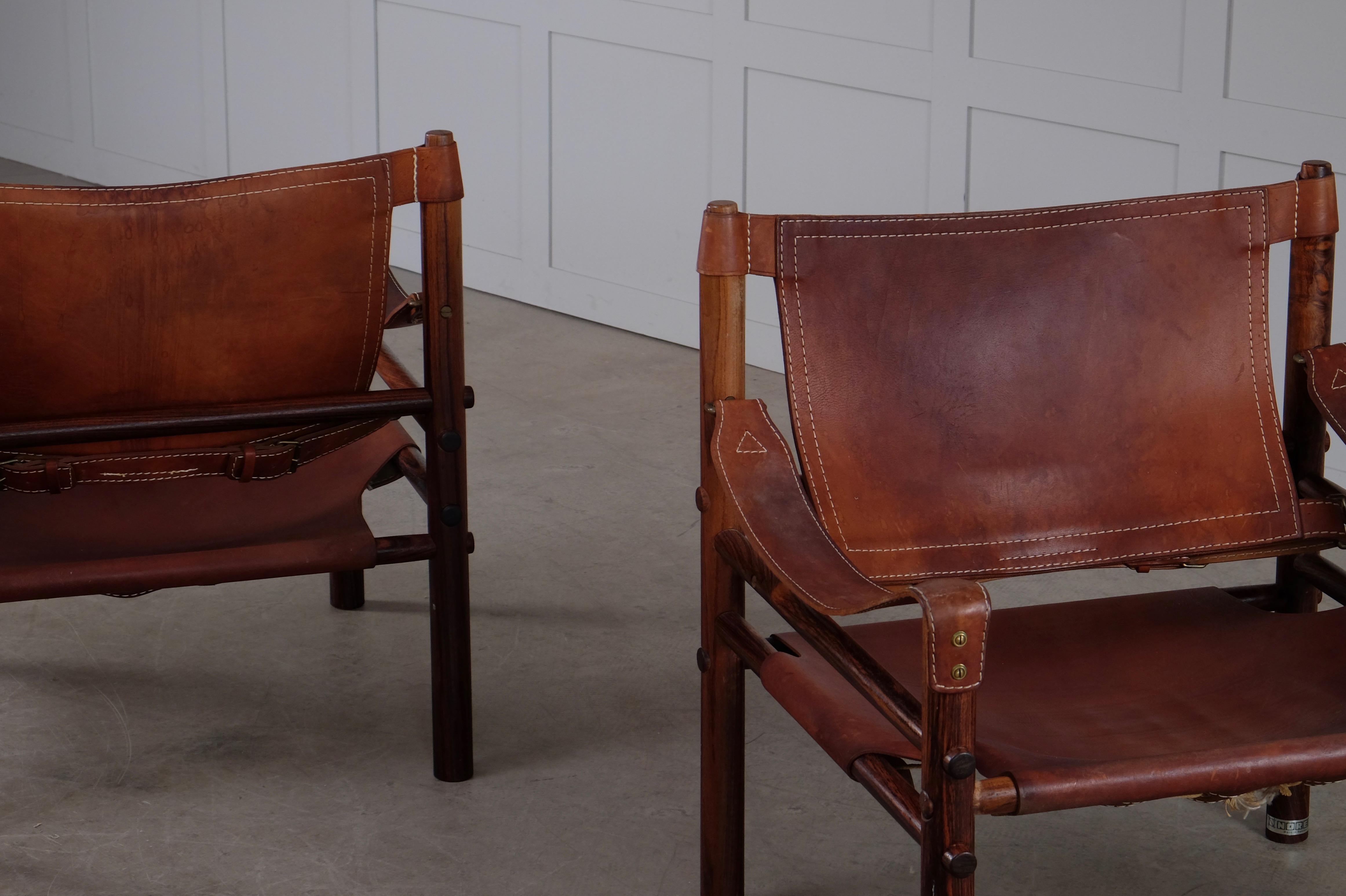 Great pair of safari chairs model Sirocco in good vintage condition. Cognac original brown leather.
Designed by Arne Norell, produced by Arne Norell AB in Aneby, Sweden, 1960s.
   





   