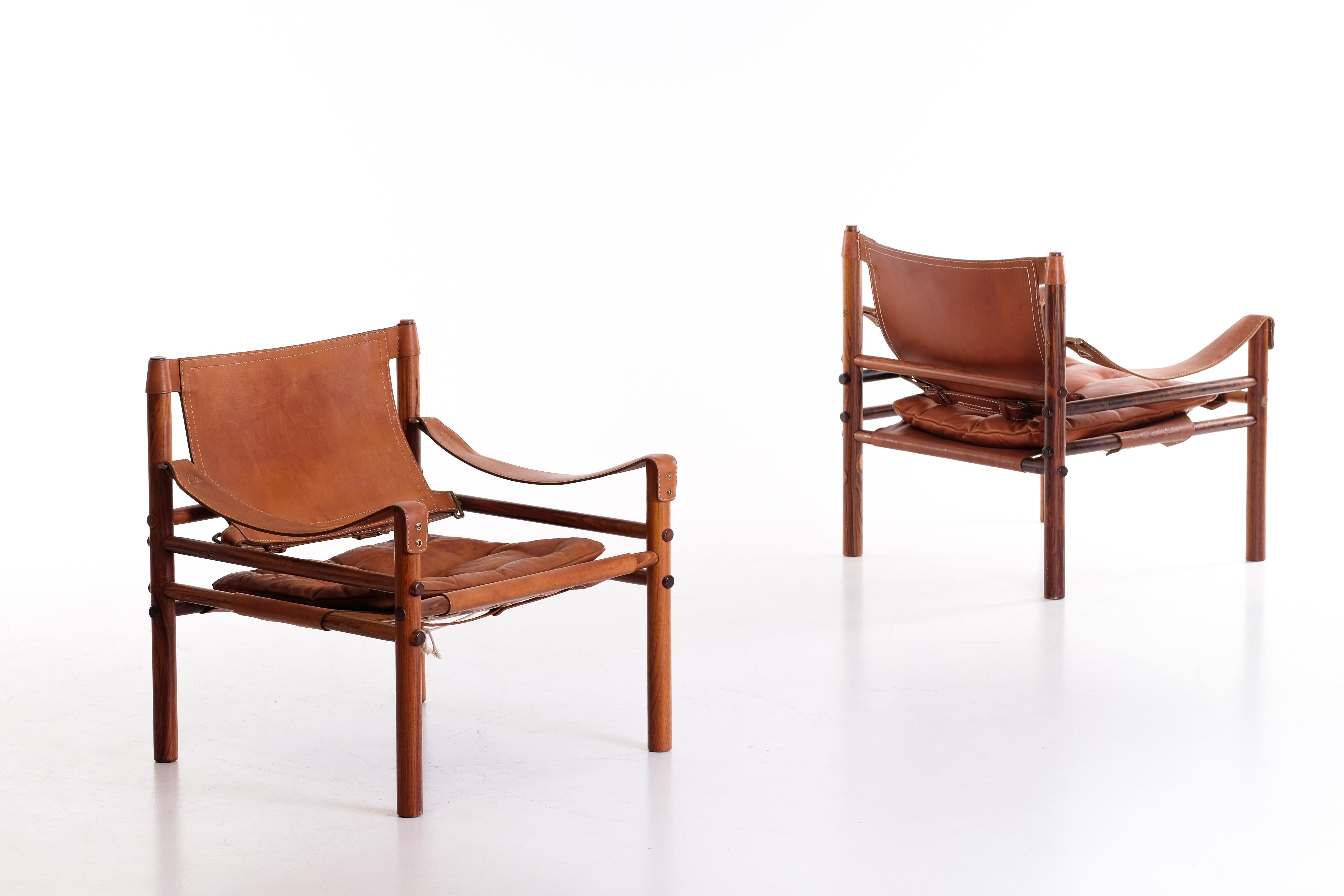 Pair of safari chairs model Sirocco in good condition with original brown leather.
Designed by Arne Norell, produced by Arne Norell AB in Aneby, Sweden, 1960s.
