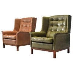 Pair of Arne Norell Lounge Chairs in Patinated Green and Cognac Leather