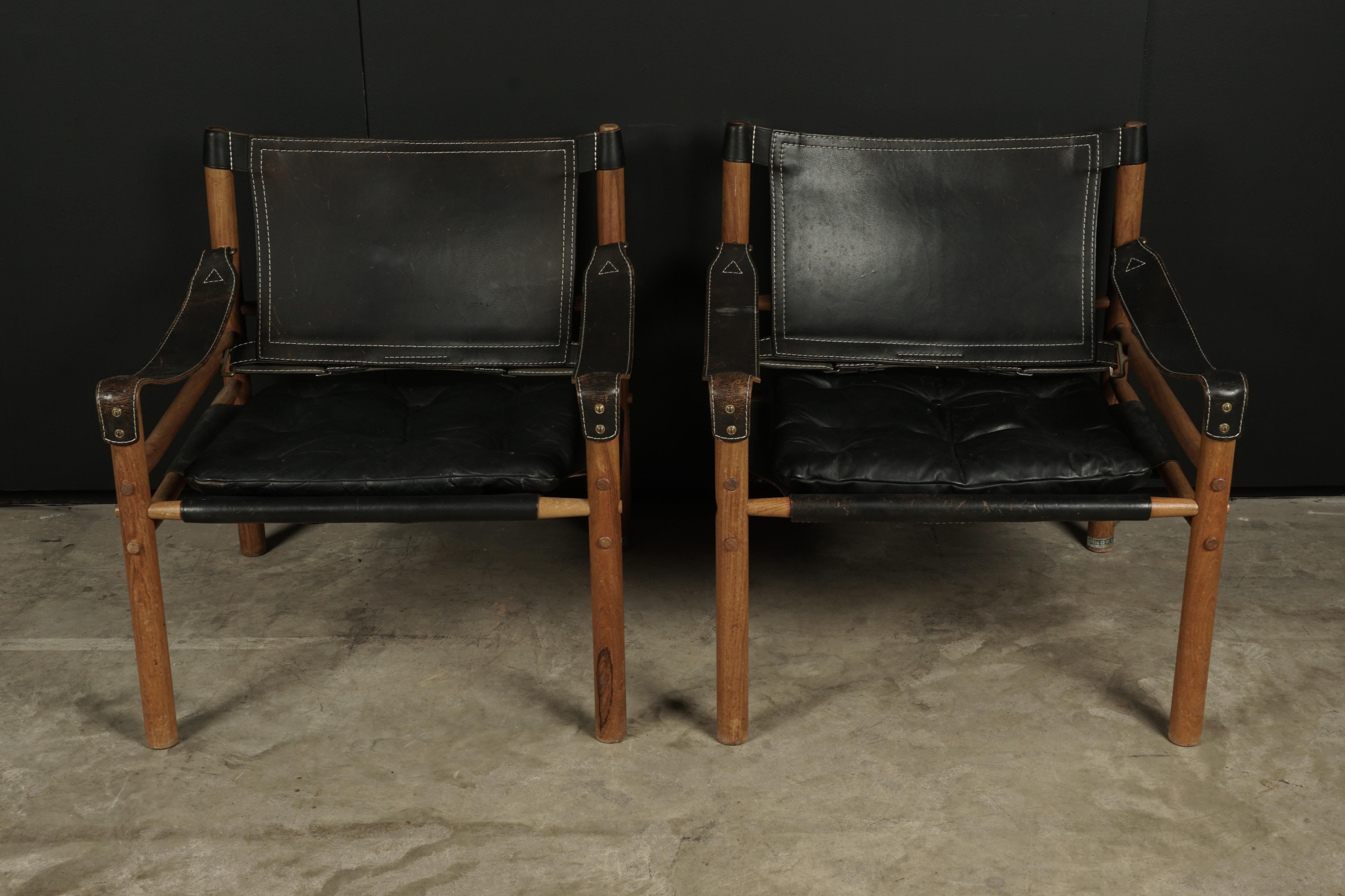 Rare pair of Arne Norell safari lounge chairs, Model Sirocco, Sweden, circa 1970. Original black leather upholstery with light wear and patina.