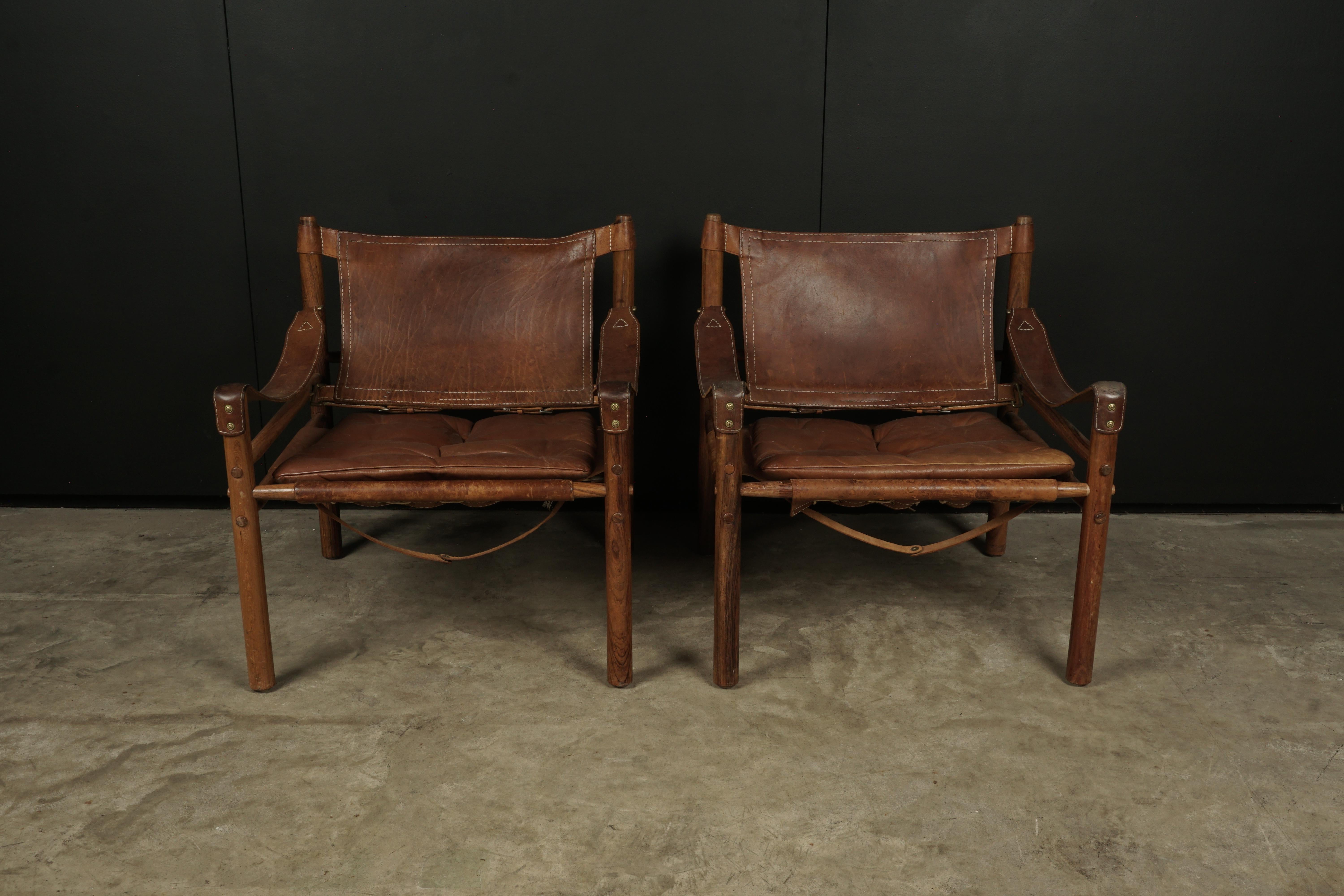 Pair of Arne Norell Safari Lounge Chairs, Model Sirocco, Sweden, 1970s. Original brown leather with nice wear and patina.