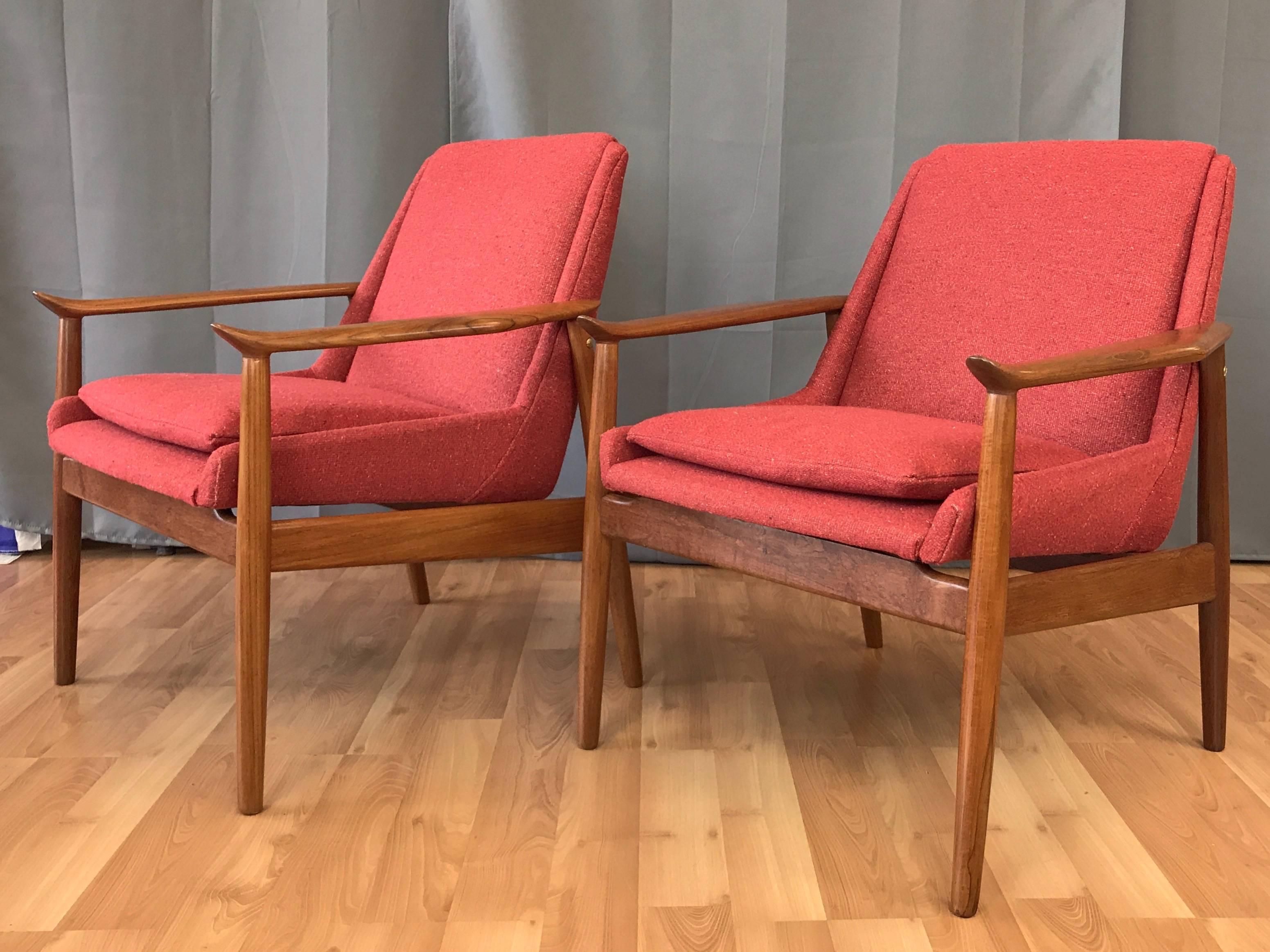 A very rare pair of No. 810 teak lounge chairs by Arne Vodder for Slagelse Møbelværk, and retailed by Illums Bolighus.

Solid teak frame is distinguished by exquisitely sculpted arms with distinctive ski-like tips that attract both the eye and the