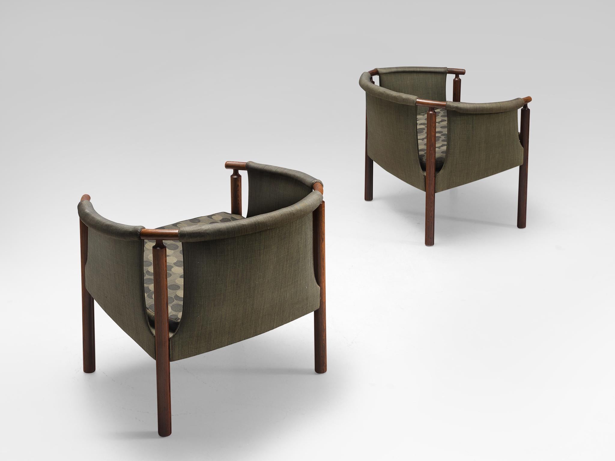 Arne Wahl Iversen for Poul M. Jessen, pair of rosewood armchairs 293/3 with green fabric, Denmark, 1950s.

This set of armchairs is upholstered with green fabric. The inventiveness of this chair lies in the open spaces next to the rosewood frame.