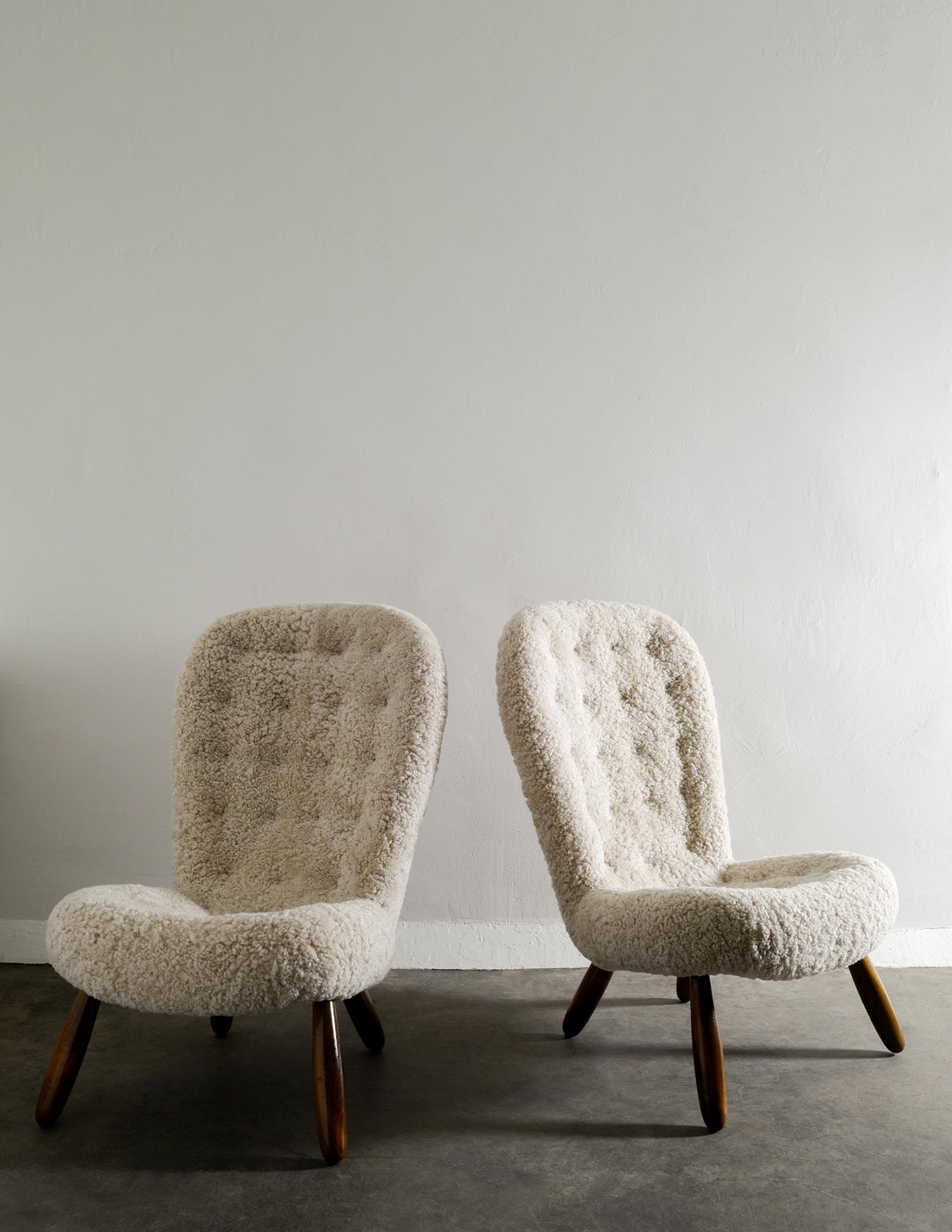 Very rare pair of midcentury / Scandinavian modern high back clam chairs designed by Arnold Madsen produced in Denmark in the late 1940s by Nordisk Stål & Møbel Central. Great matching pair and both chairs have been professionally restored and