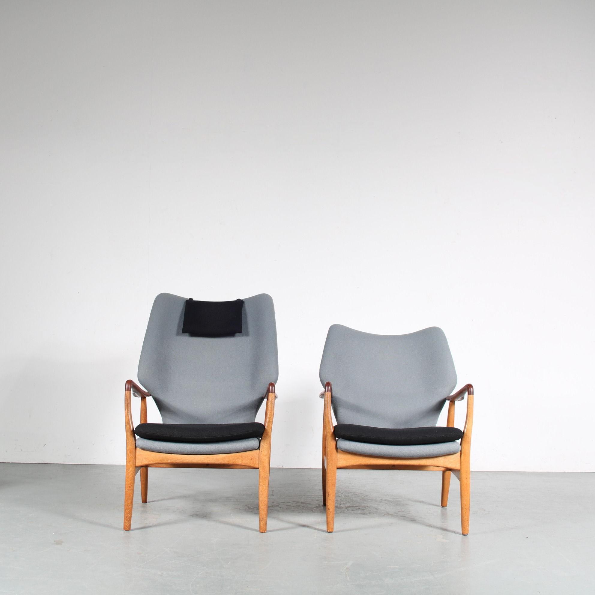 an outstnading set of two easy chairs designed by Arnold Madsen & Henry Schubell and manufactured by Bovenkamp in the Netherlands around 1950.

The set contains one highback and one lowback “ladies” chair. Both chairs are upholstered in high