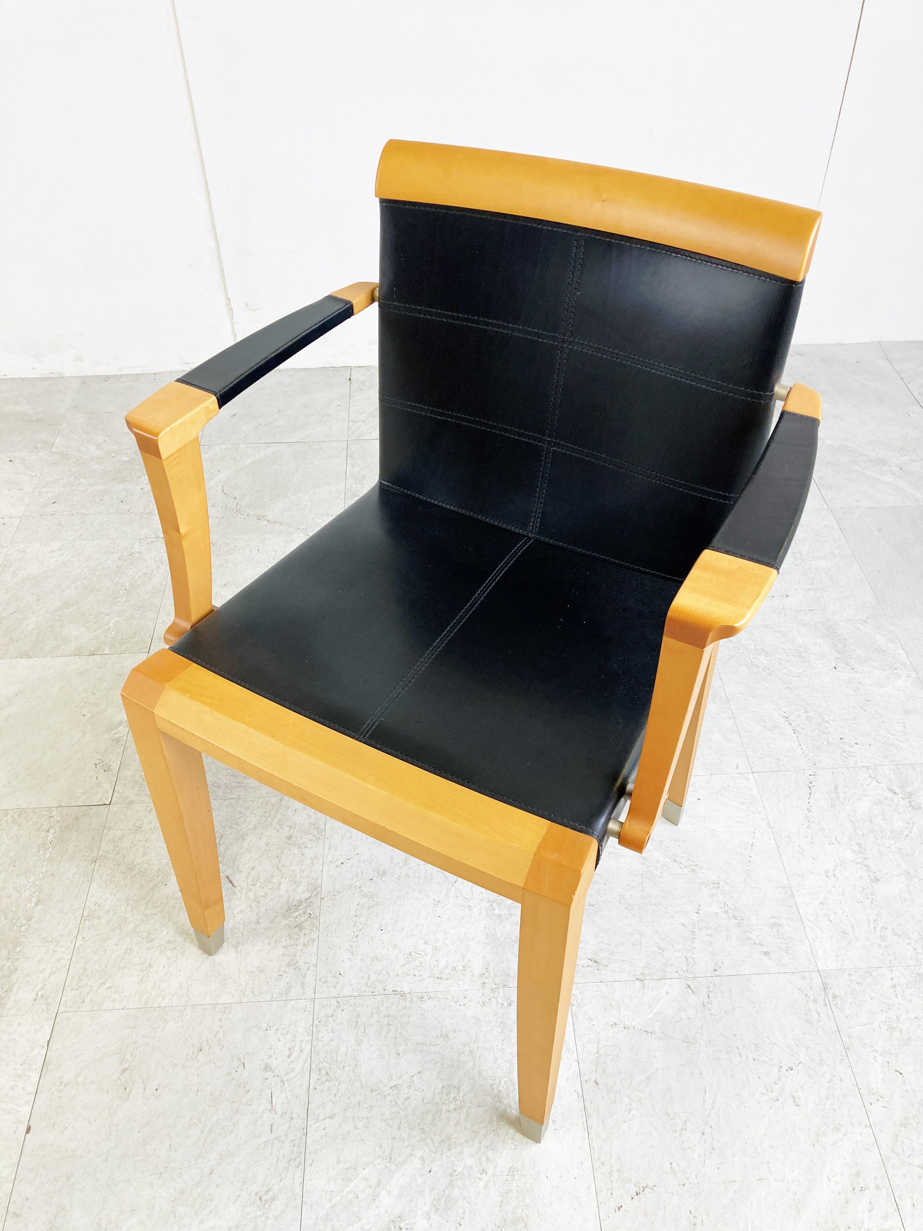 Pair of very elegant cherrywood dining chairs with armrests model 'ARO' designed by Chi Wing Lo for Giorgetti.

1990s - Italy

Good condition

Dimensions:
Height: 82cm/32.22