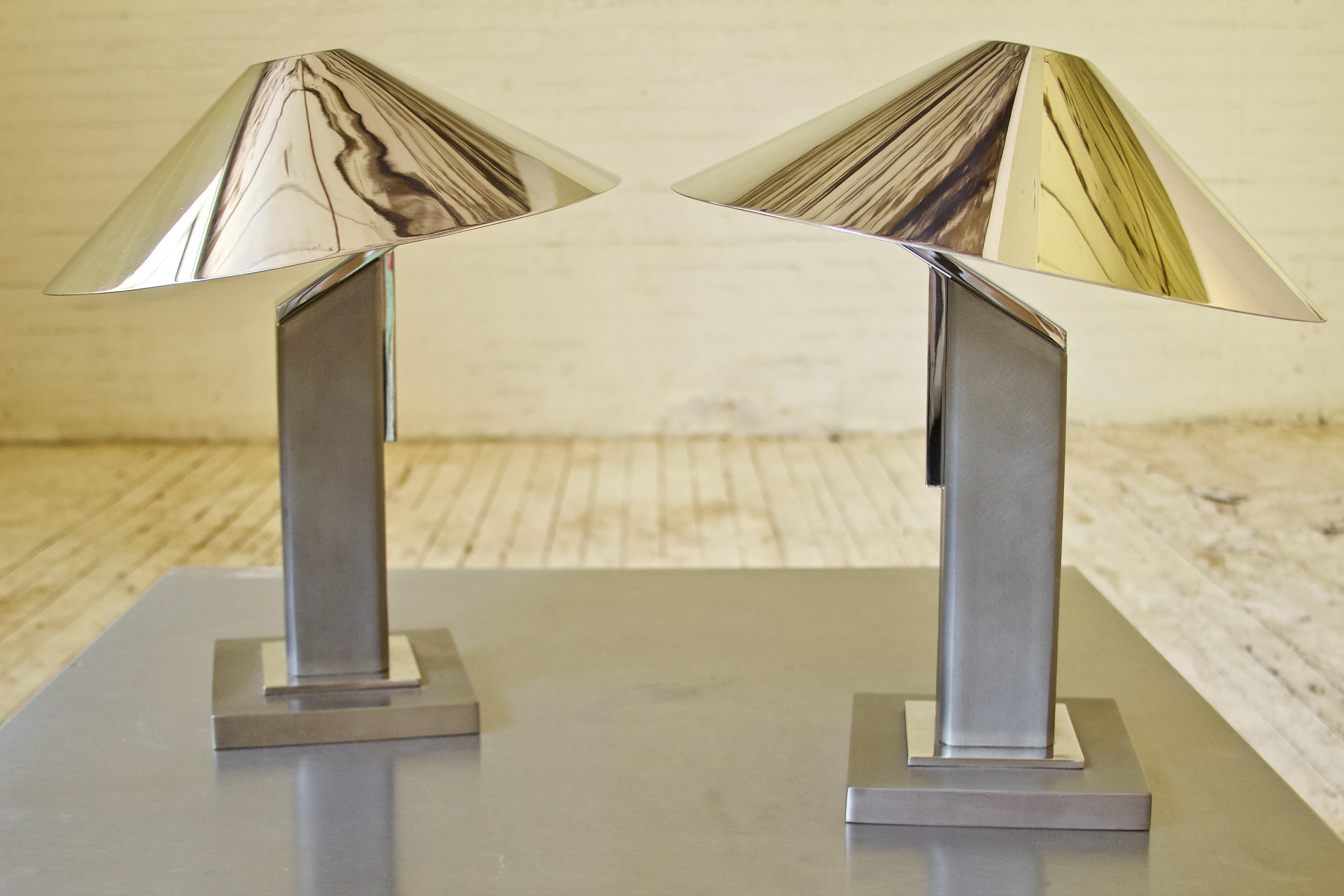 Striking pair of modernist table lamps by Columbian designer Sergio Orozco with cantilevered steel construction and polished steel shades. Great weight and quality to this pair, nice contrast created by different steel finishes. This design takes on