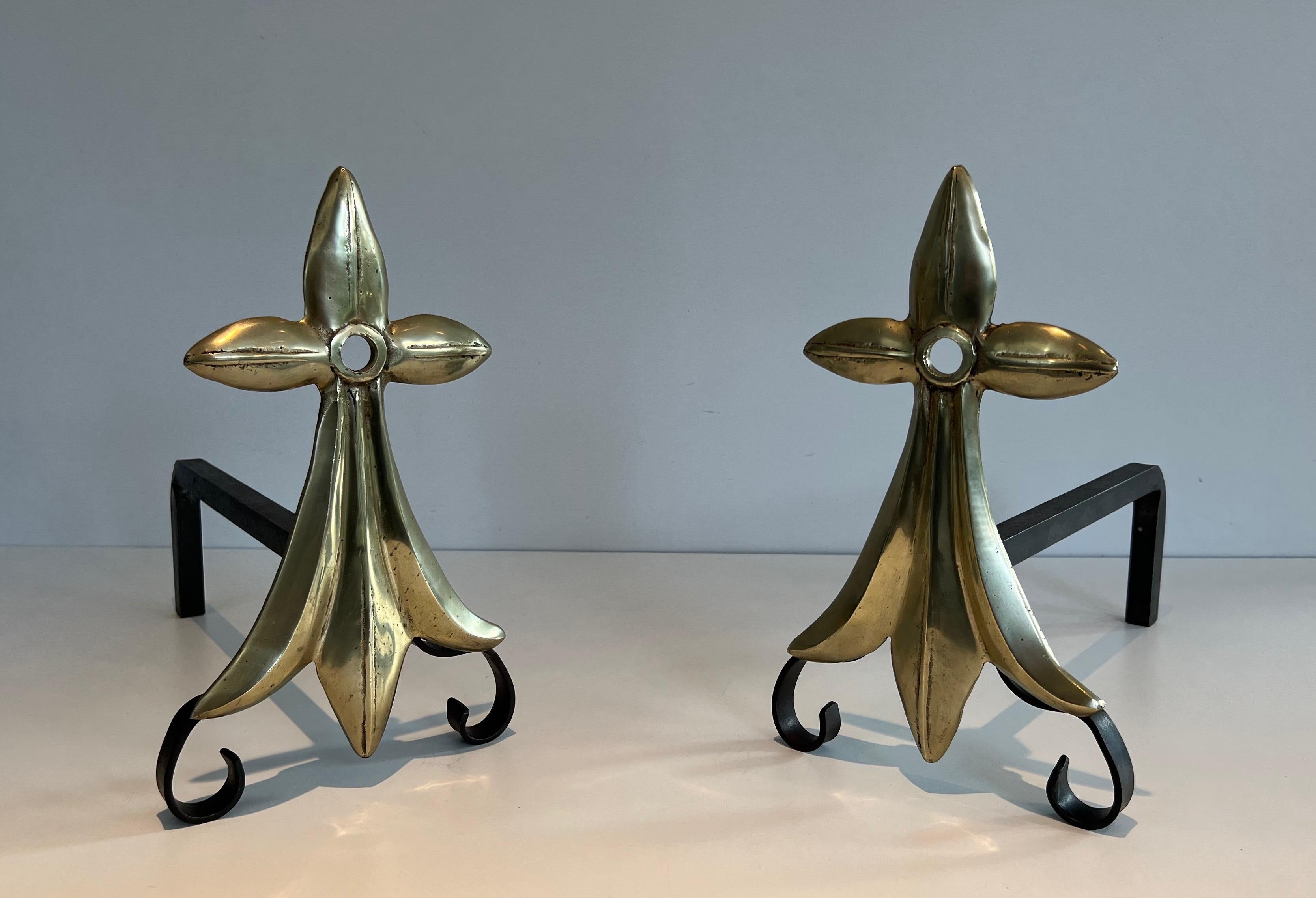 This pair of Art & Crafts ermine tail andirons is made of bronze and wrought iron. This is a French work maked MR with the image of an ermine tail. Circa 1900.