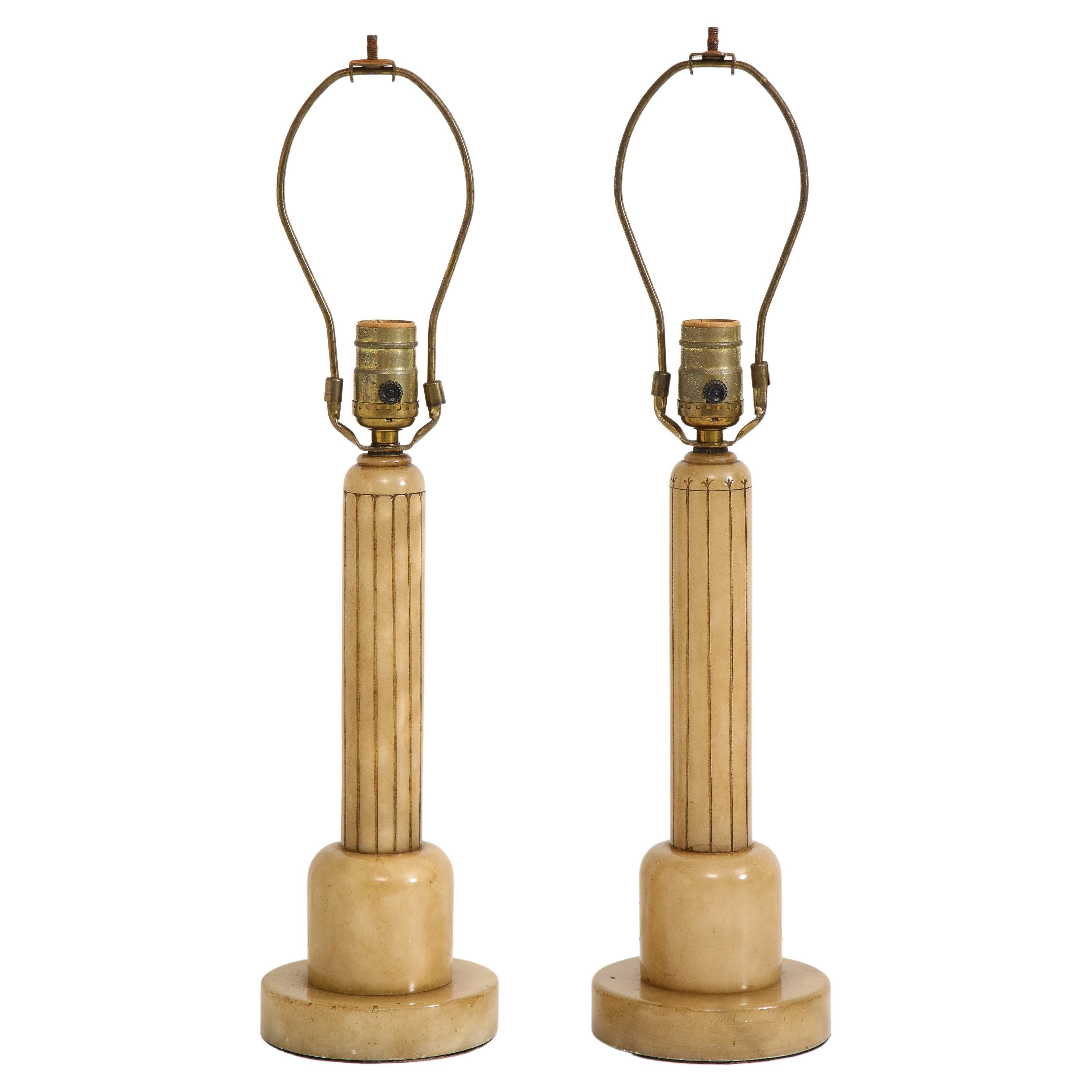 Pair of 1930s art deco polished alabaster table lamps with cream pleated shades. Alabaster bases feature incised design. 

Base 20.5