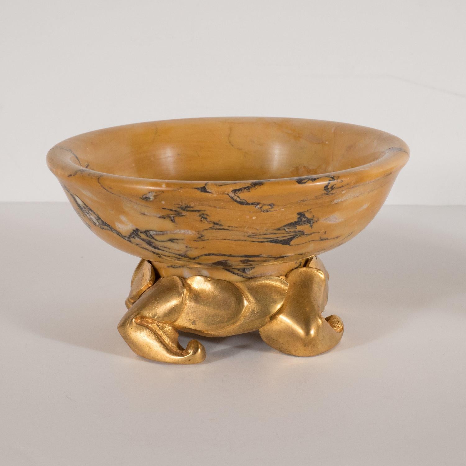 This exquisite pair of decorative dishes were realized in France at the beginning of the 20th century. They feature circular tops with gently reclined sides and a flat bottom carved from amber gold marble with charcoal veins running throughout. The
