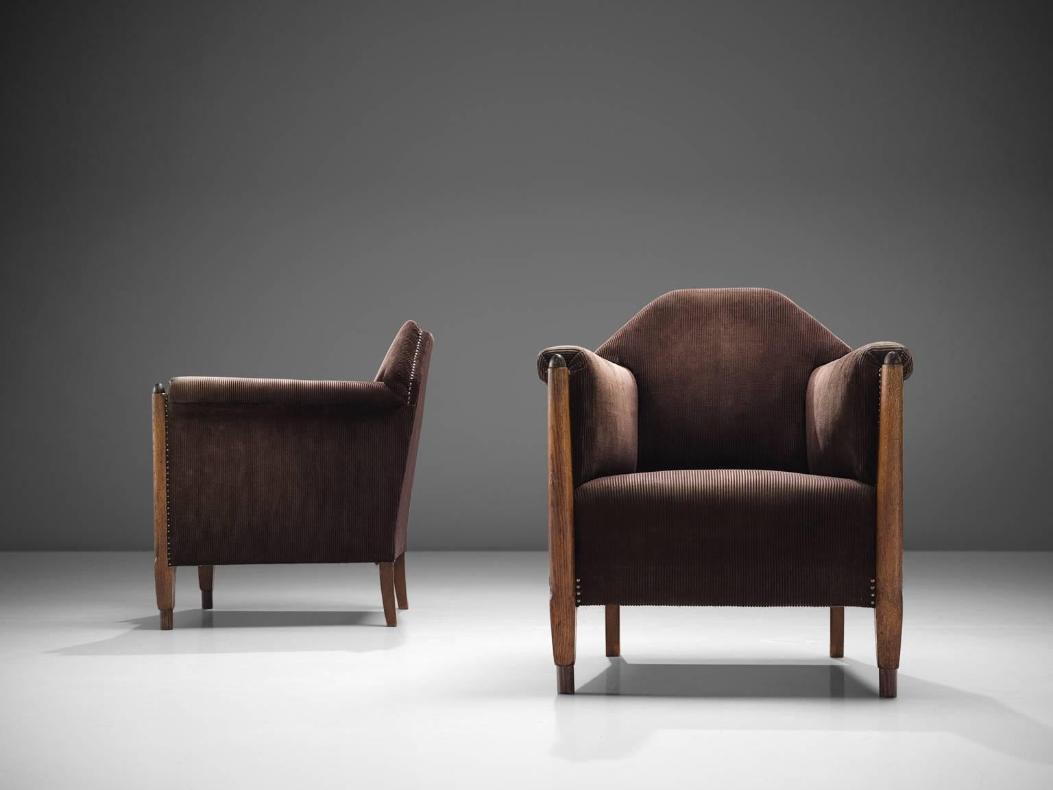 Set of lounge chairs, brown purple velvet fabric, wood, The Netherlands, circa 1920 

This set of architectural chairs feature high, geometric backs, high armrests and thick, comfortable cushion. These chairs feature typical traits of the