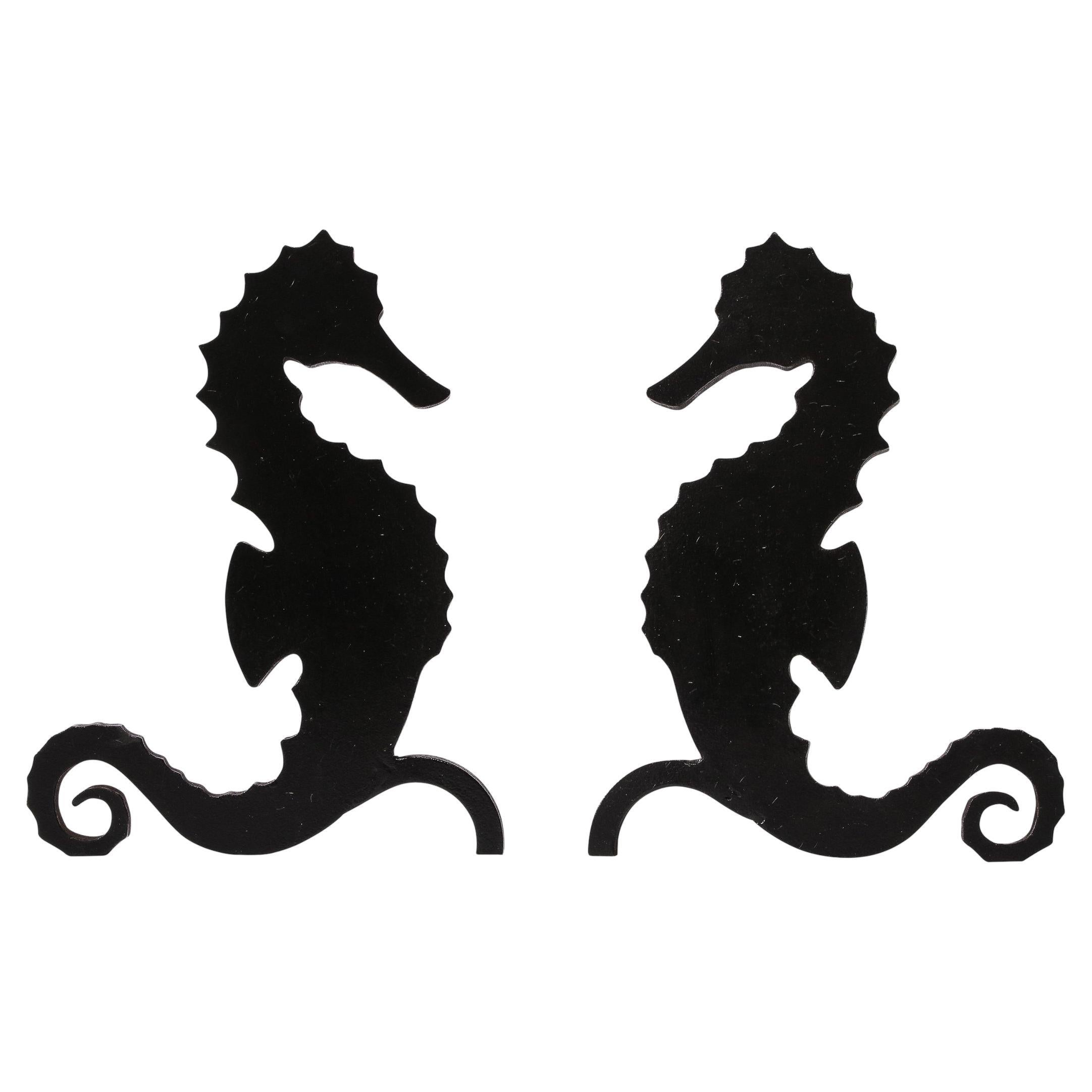 This beautiful pair of sculptural Art Deco andirons were realized in France circa 1930. They feature a dramatic and graphic silhouette of seahorses, rendered with amazing fidelity in patinated black enamel. The creatures appear at once highly