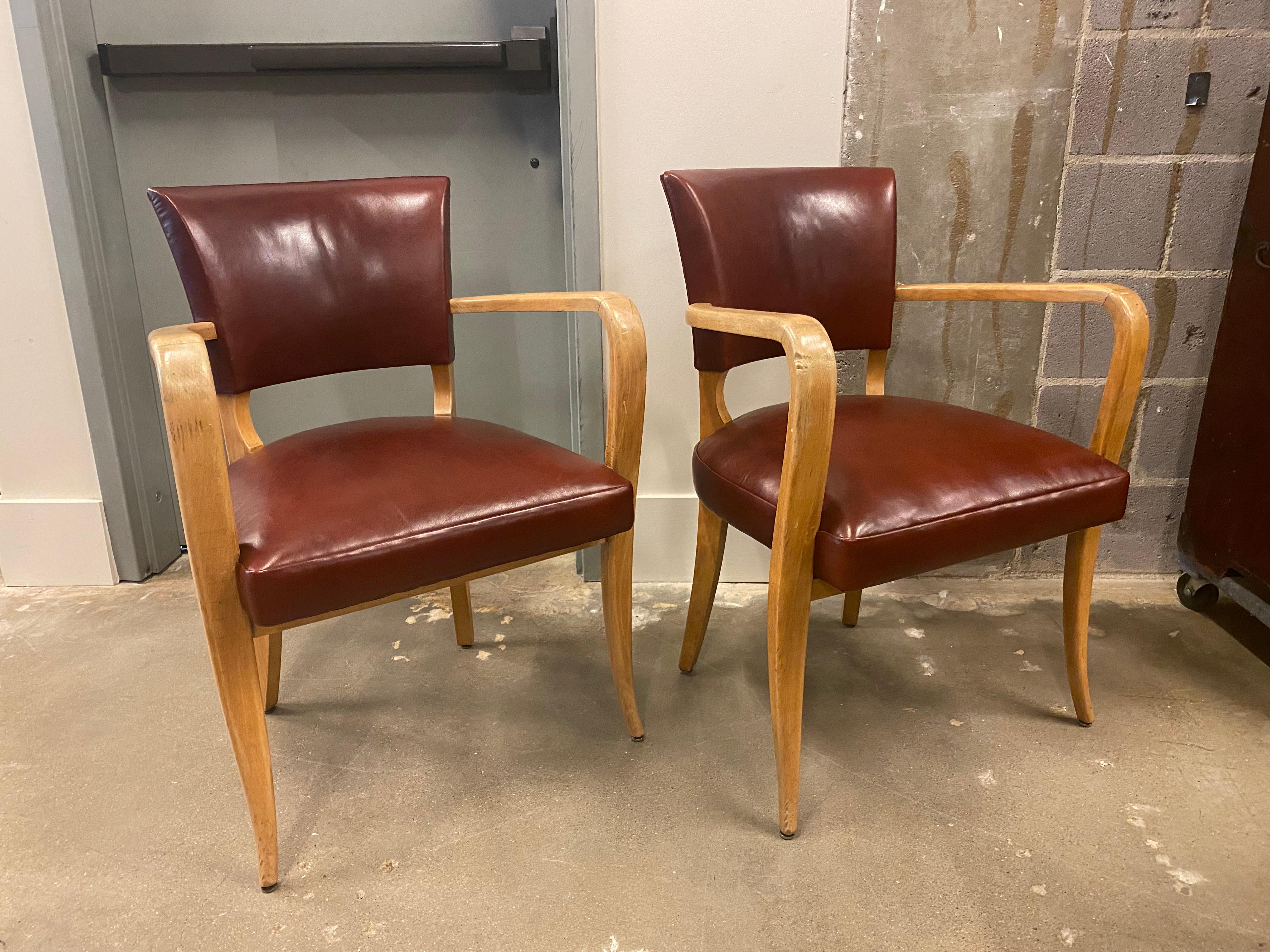 With Art Deco to early Mid-Century Modern styling, these armchairs are quite versatile. Wood frames with newly upholstered seats and backs in oxblood leather. Comfortable and sturdy as dining chairs, bridge chairs, or game table chairs. France,