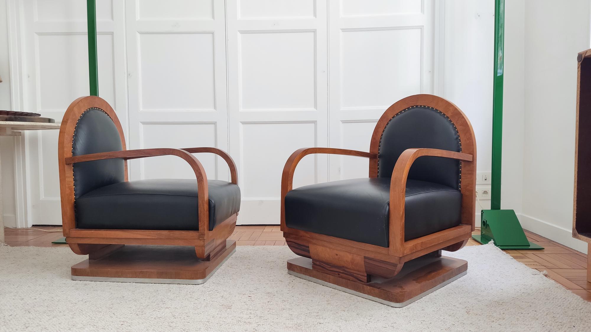 Elegant pair of rounded armchairs in an art deco style. Nice wood work, especially with veined details at the feet.