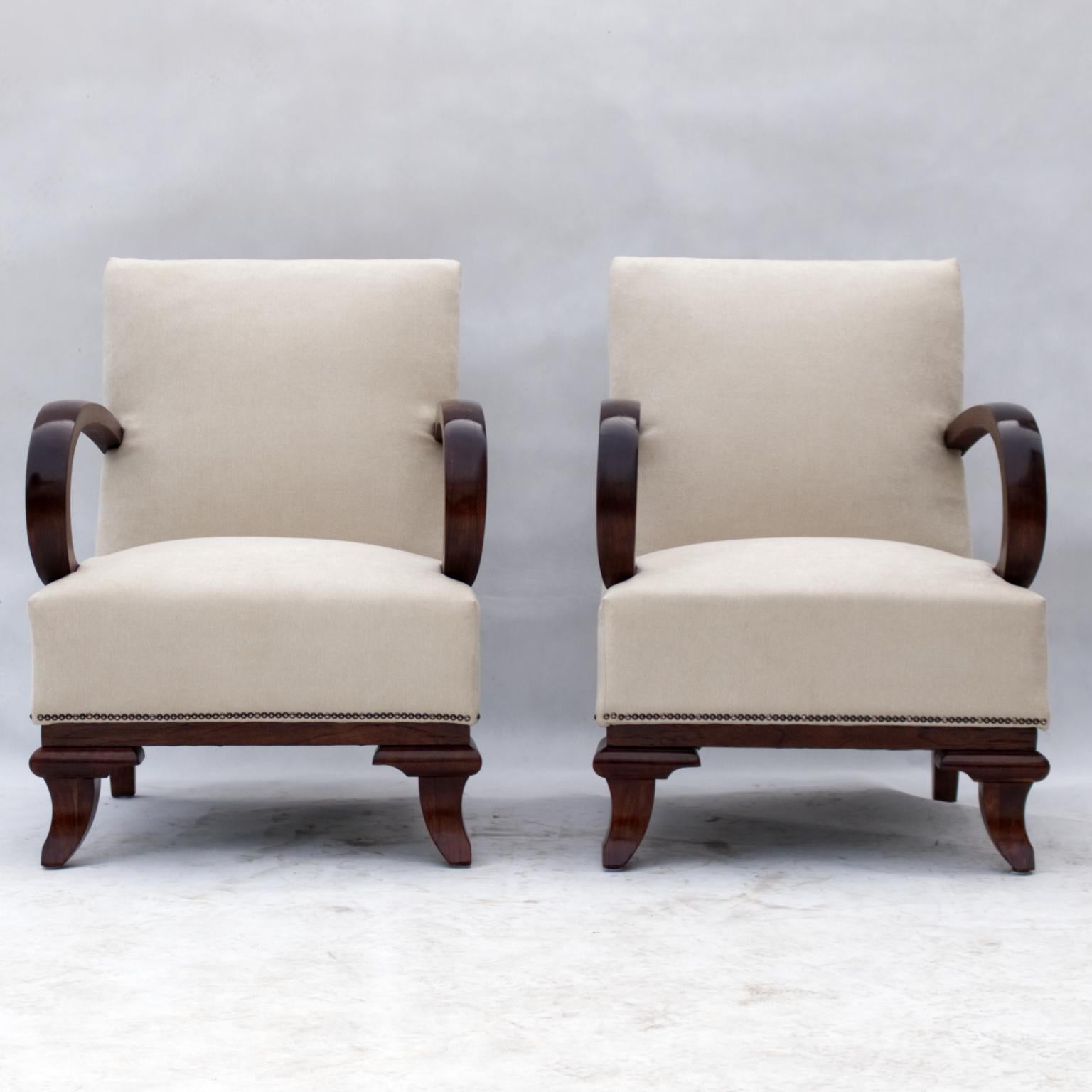 Fully restored pair of Art Deco armchairs in new upholstery and wood arms and legs.

Attributed to Lajos Kozma.