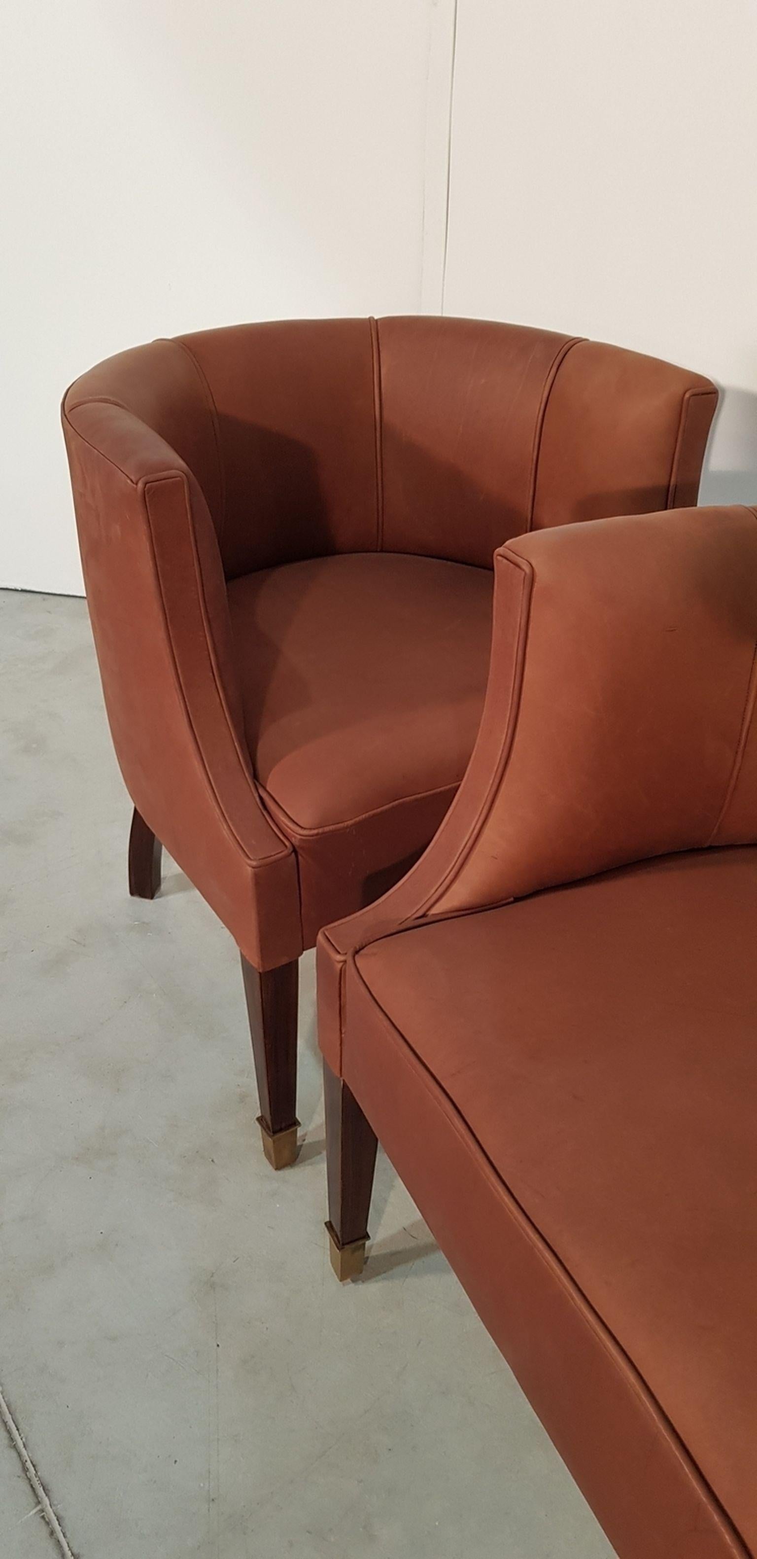 Nice pair of Hungarian armchairs with polished walnut legs at the bottom copper. Re-upholstered with new brown leather. Art Deco, 1930s.