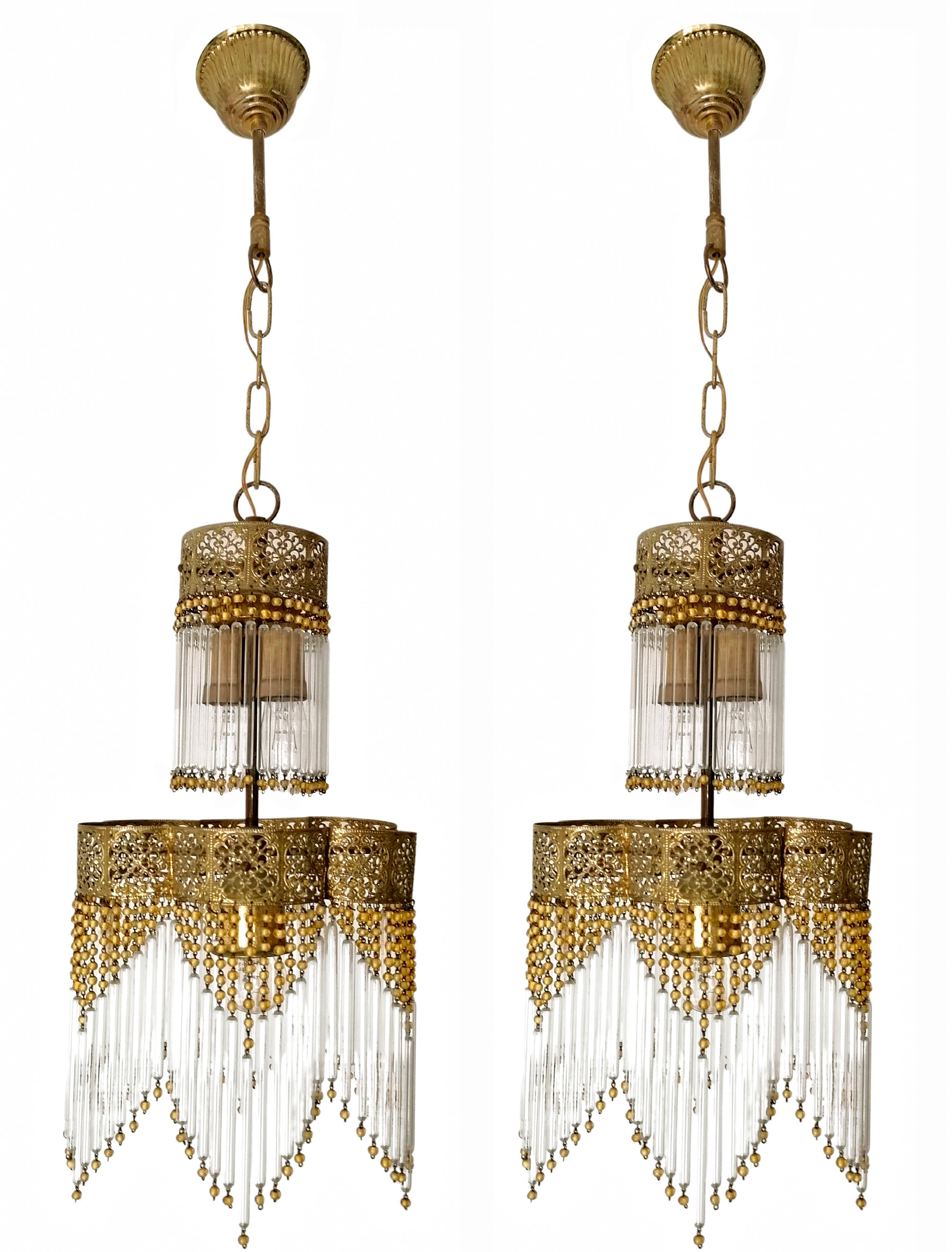 Lovely Pair of French Art Deco and Art Nouveau gilt brass three-light chandelier with clear glass rods and amber glass pearls making a gorgeous sparking lighting effect! 
Age patina.
Dimensions:
Height: 33.08 in.(chain = 6,3 in.) /84 cm (chain =