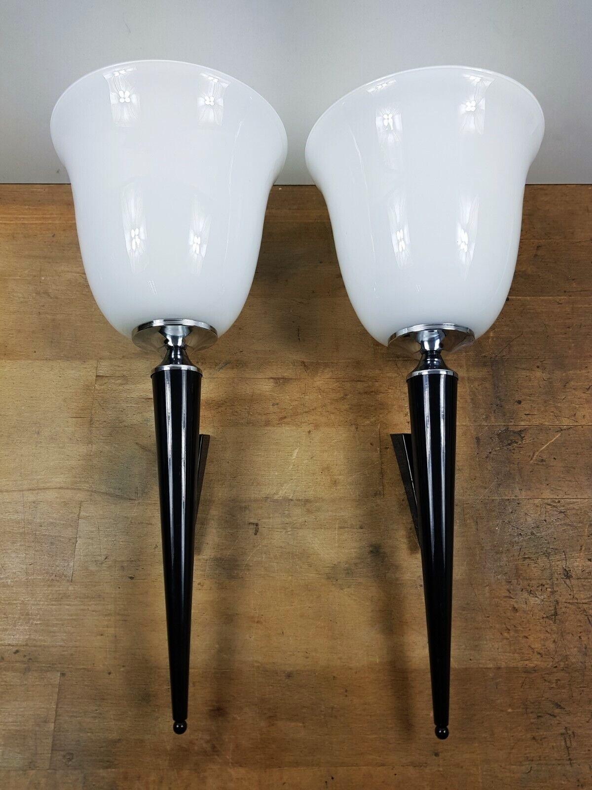 A pair of tall Art Deco torchiere wall lights, France 1950s. Conical base of black lackered metall parcel chrome with a large opaline shade.
Each sconce takes one E27 screw light bulb up to 60watt. LED bulbs can also be used.
Dimensions :
Height: