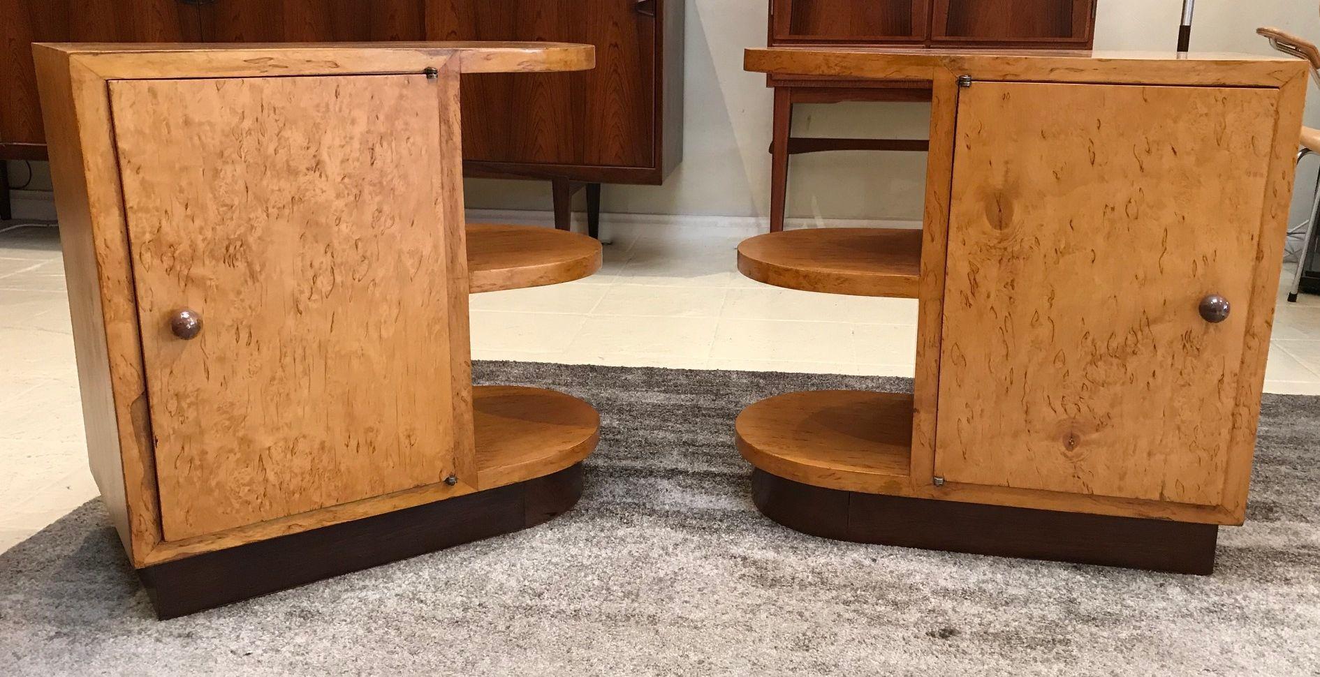 Pair of Swedish modernist Art Deco Karelian birch and palisander bedside cabinets. Curved cantilevered shelving and geometric straight line cabinets resting on a curved inverted plinth. The interior is lined with palisander and has a single shelf.