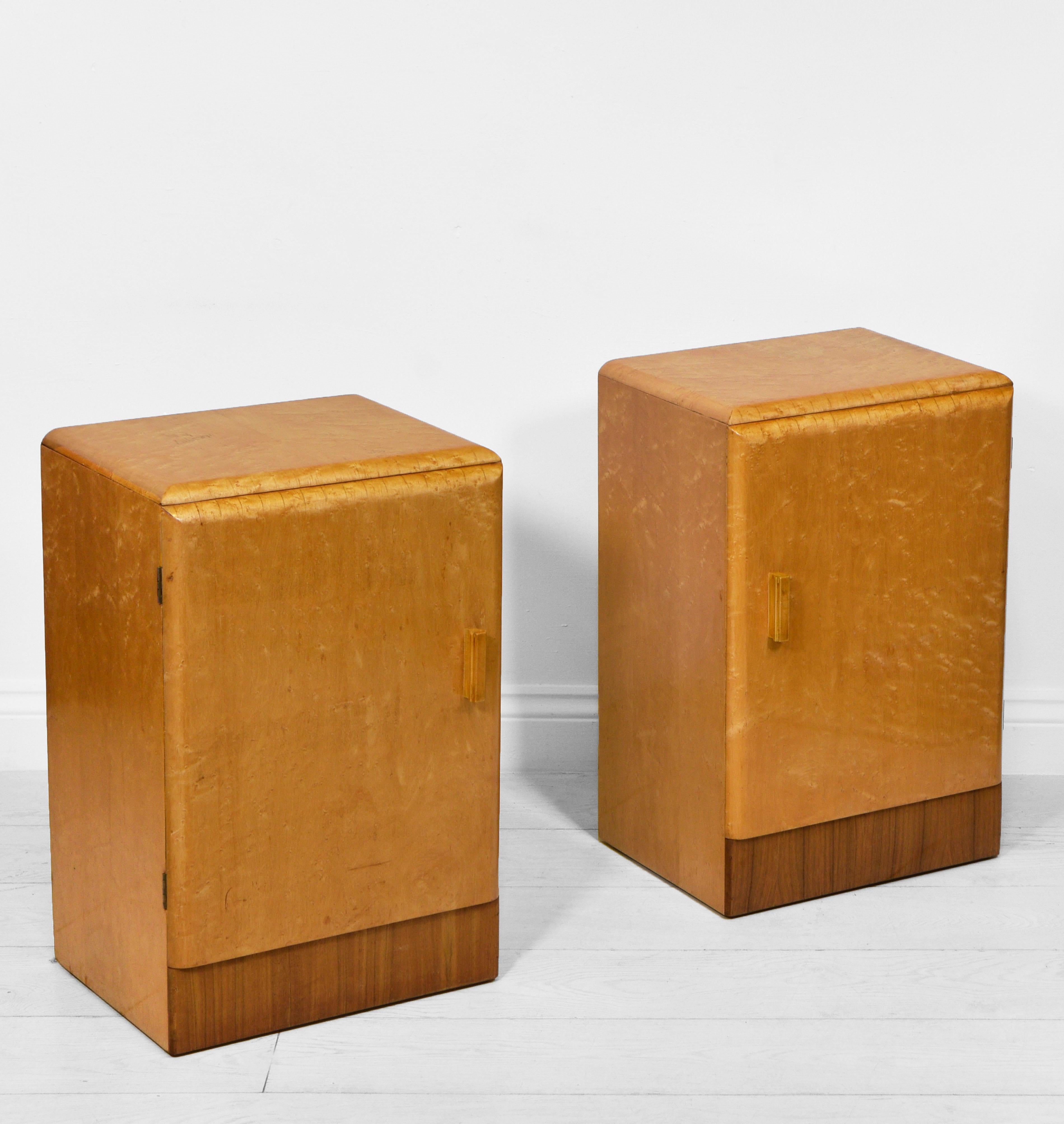 A pair of matching Art Deco bird's eye maple & walnut bedside cabinets. Circa 1930s.

The cabinets are veneered in bird's eye maple, with a contrasting veneered walnut front frieze. They are in good original condition, and have a lovely even