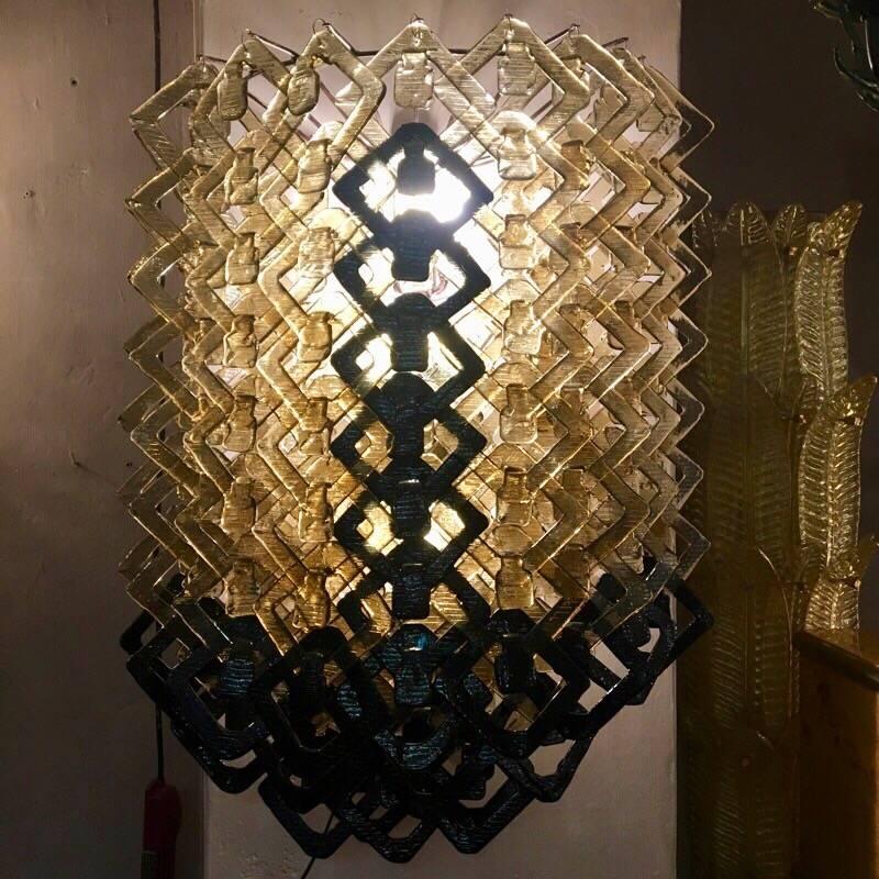 Pair of Art Deco black and amber Murano glass Italian big sconces.
The sconces consist of amber and black hand blown glasses hang each other with a waterfall effect.
Five light bulbs per sconce.
A single sconce can be sold individually.