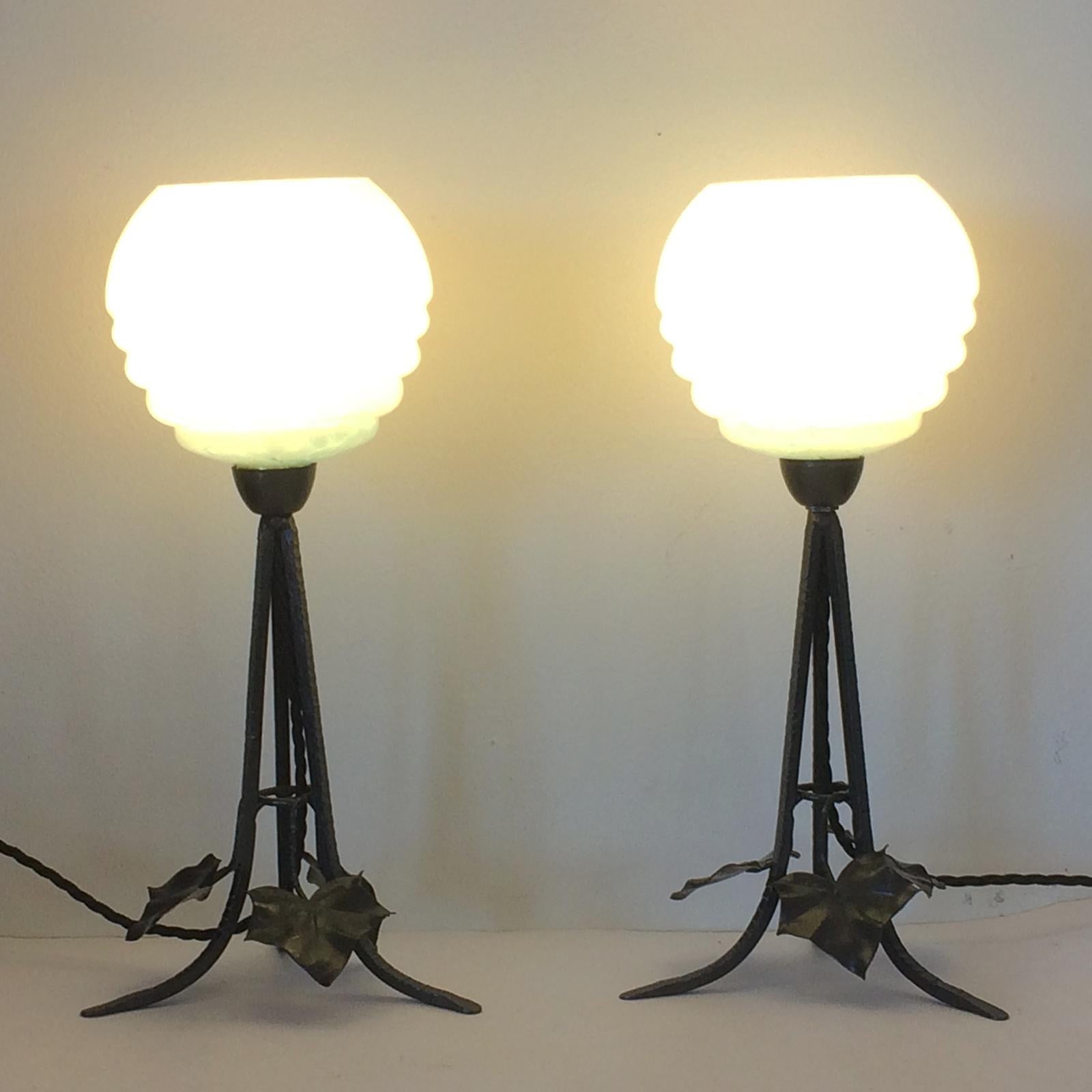 Art Deco pair lamps original “Blue Sky Clouds”, symmetrical, stepped shades with hand-wrought iron bases with ivy leaves and three, cross hammered vertical supports with slayed feet to each. Both in perfect original condition, no damage and no