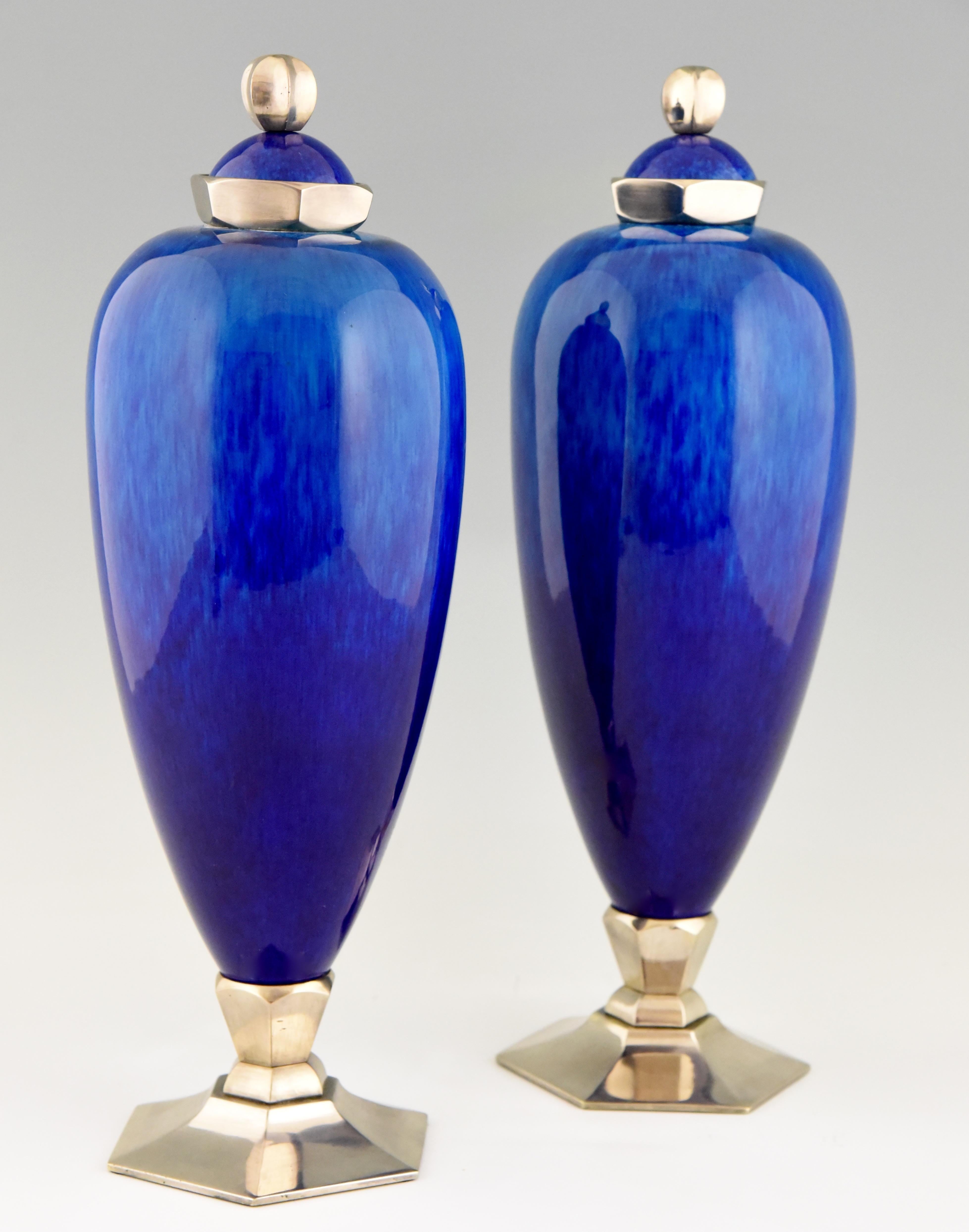 Elegant pair of blue Art Deco ceramic vases or urns by Paul Milet for Sèvres.
The vases have bronze decorations with a silver patina. They are signed with the artists initials and marked Sèvres. Created in France, circa 1925.