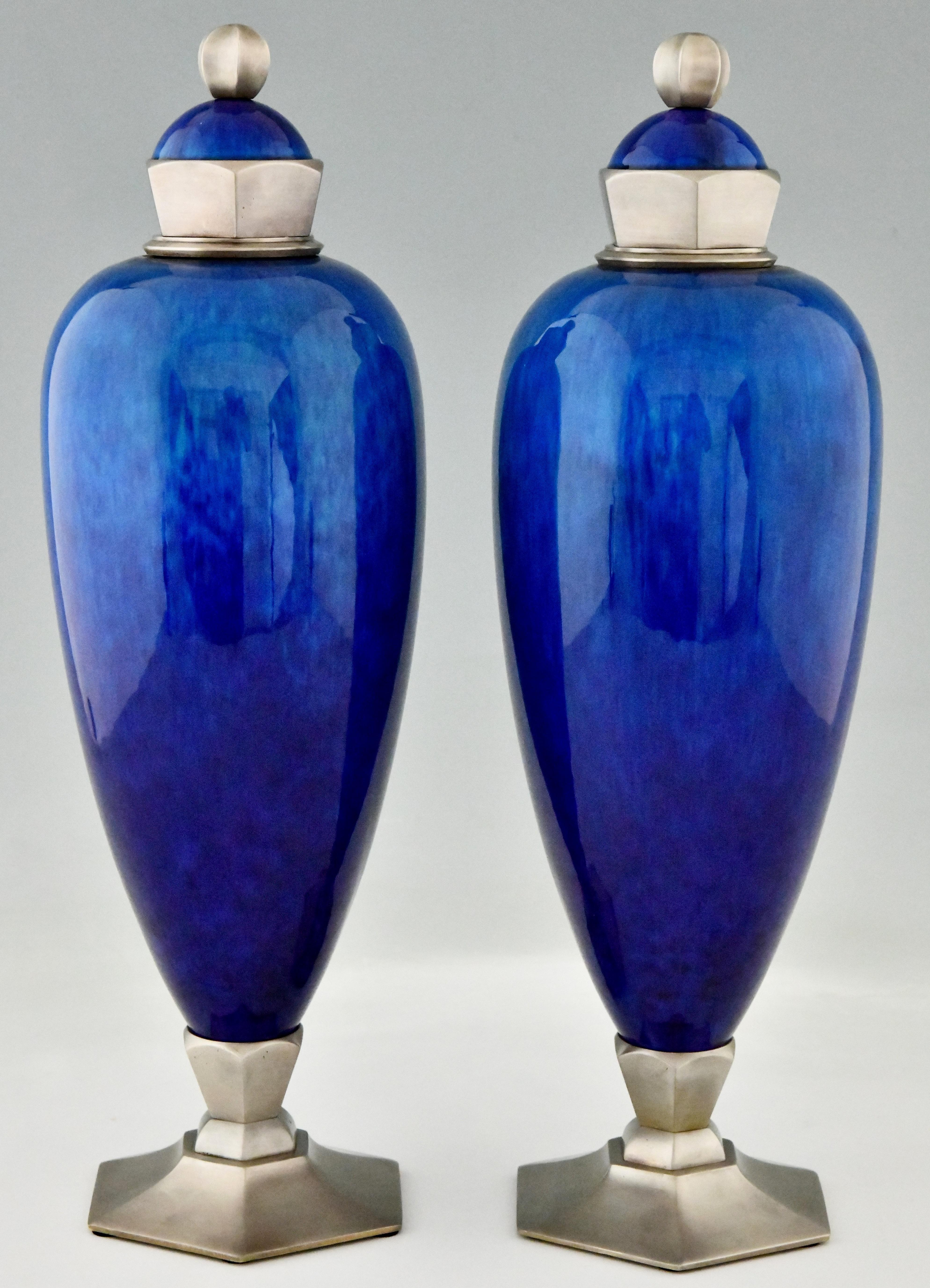Elegant pair of blue Art Deco ceramic vases or urns by Paul Milet for Sèvres.
The vases have bronze decorations with a silver patina. They are signed with the artists initials and marked Sèvres. Created in France, circa 1925.