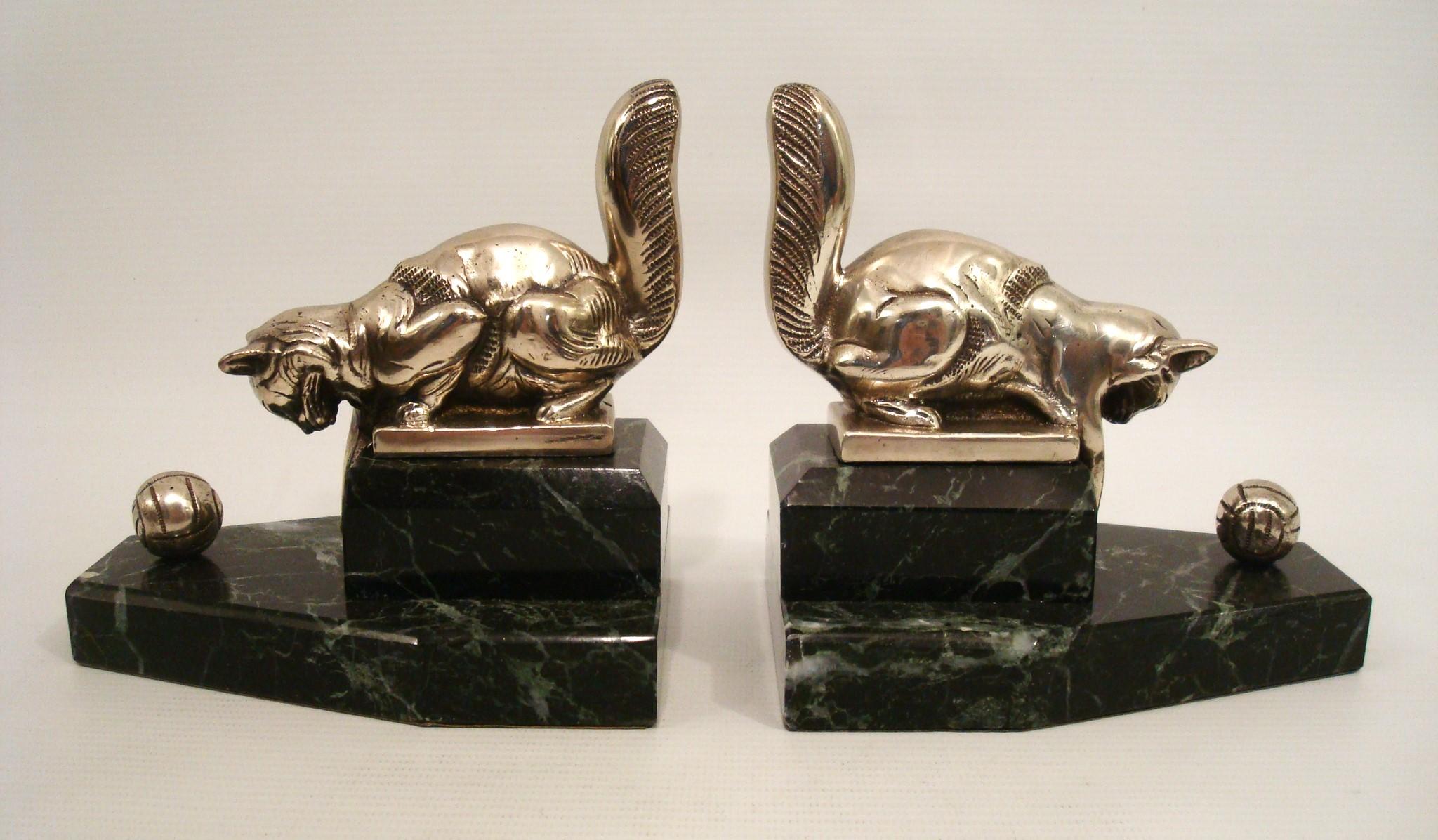 Pair of art deco bookends Cat playing with a Ball. France 1925

Nice pair of Art Deco bookends with sculptures of cats playing what a ball. Made of silvered bronze, on marble bases. In good condition with minor signs of age. Made in France around