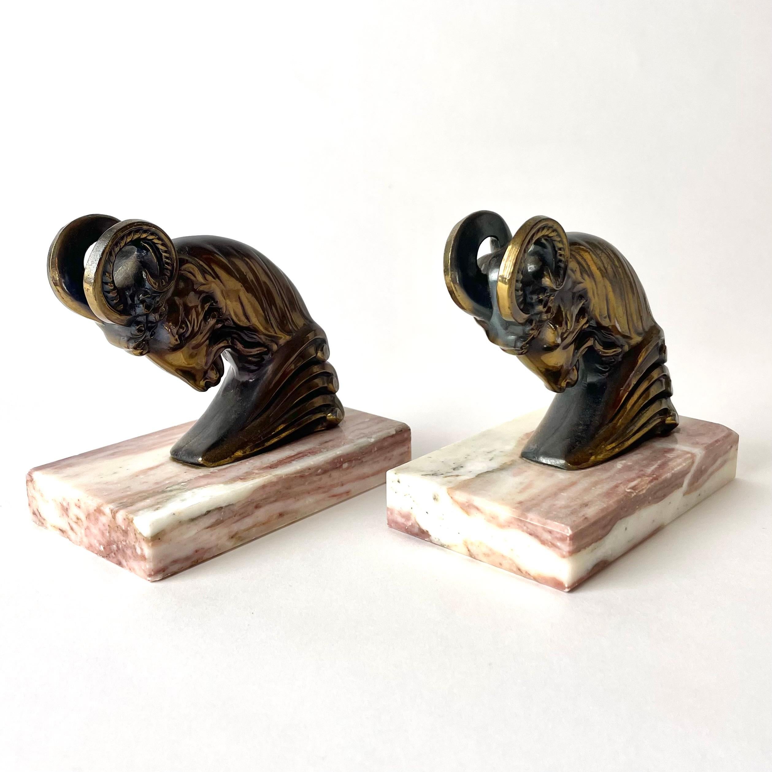 Patinated Pair of Art Deco Bookends from the 1930s with very period and powerful rams. For Sale