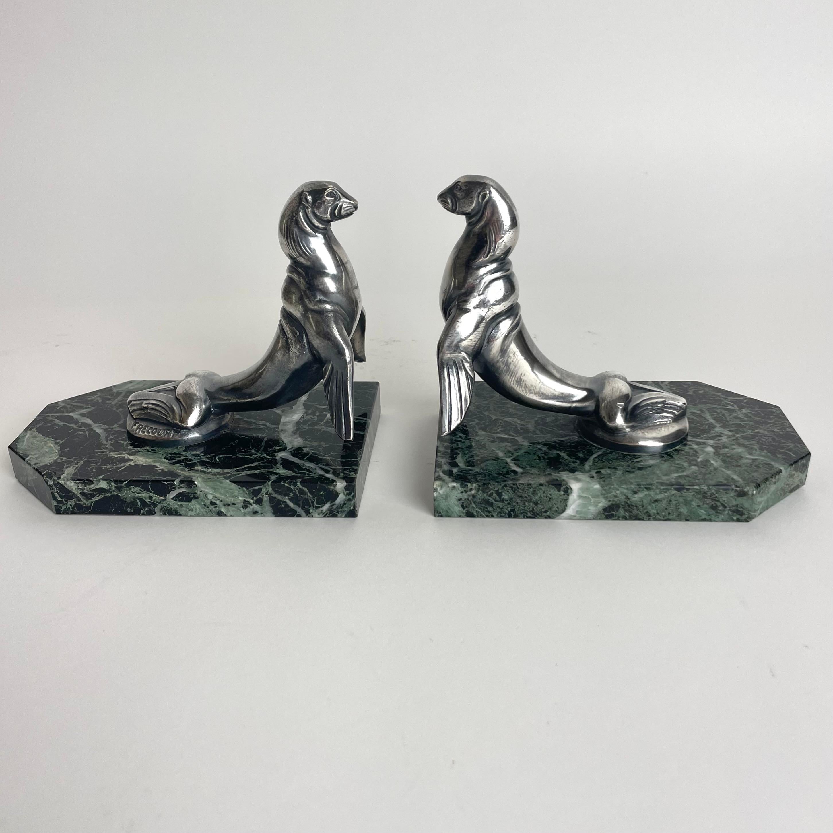 A charming Pair of Art Deco bookends of Sea Lions signed by Maurice Frecourt (France 1890-1961) in marble and silver plate. Made in France during the 1920s.

Wear consistent with age and use