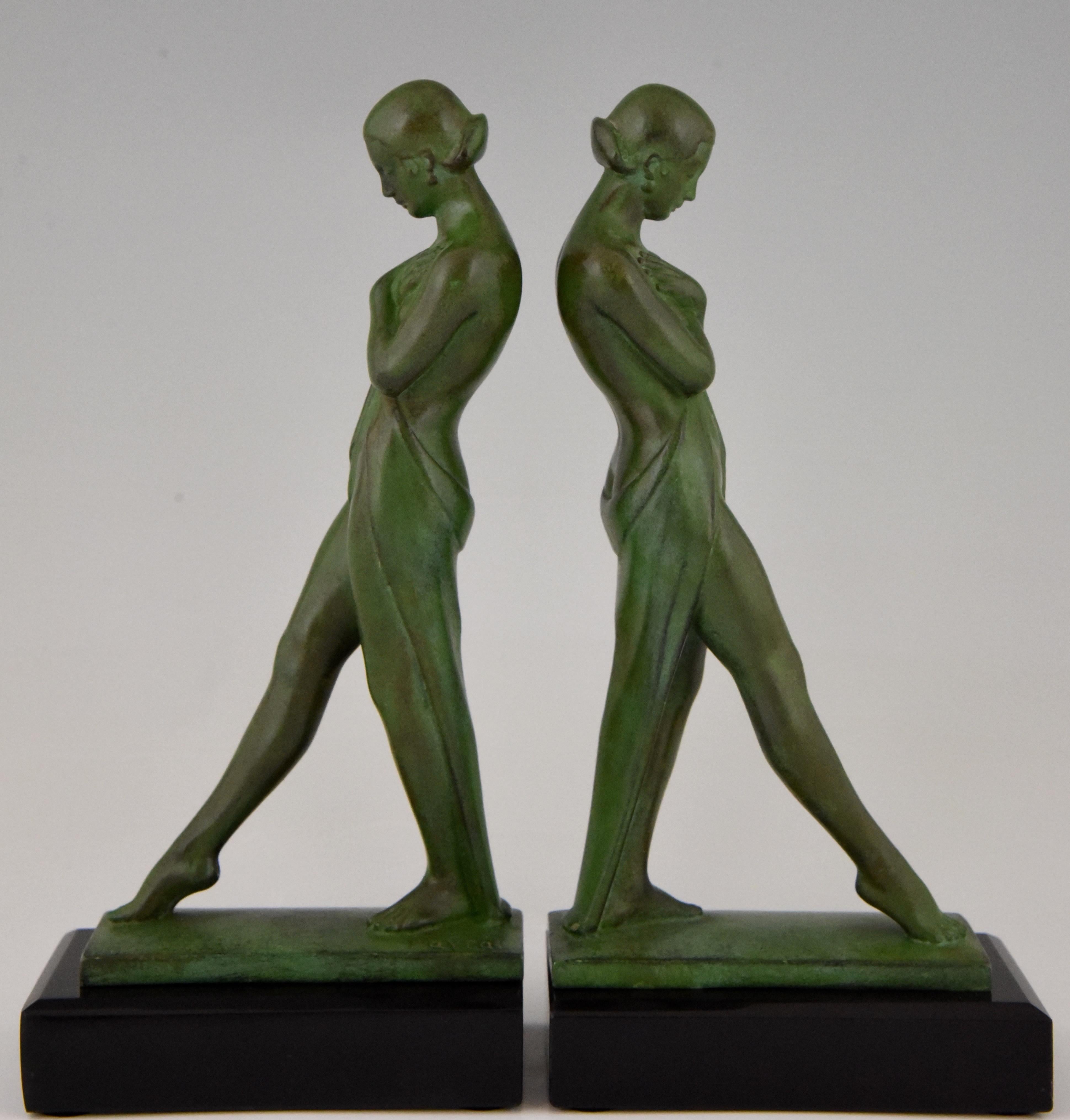 Beautiful pair of Art Deco bookends picturing standing draped nudes.
Sigend by Fayral, Pierre Le Faguays and marked by the founder Max Le Verrier, France, 1930. Art metal with green patina on Belgian black marble base.