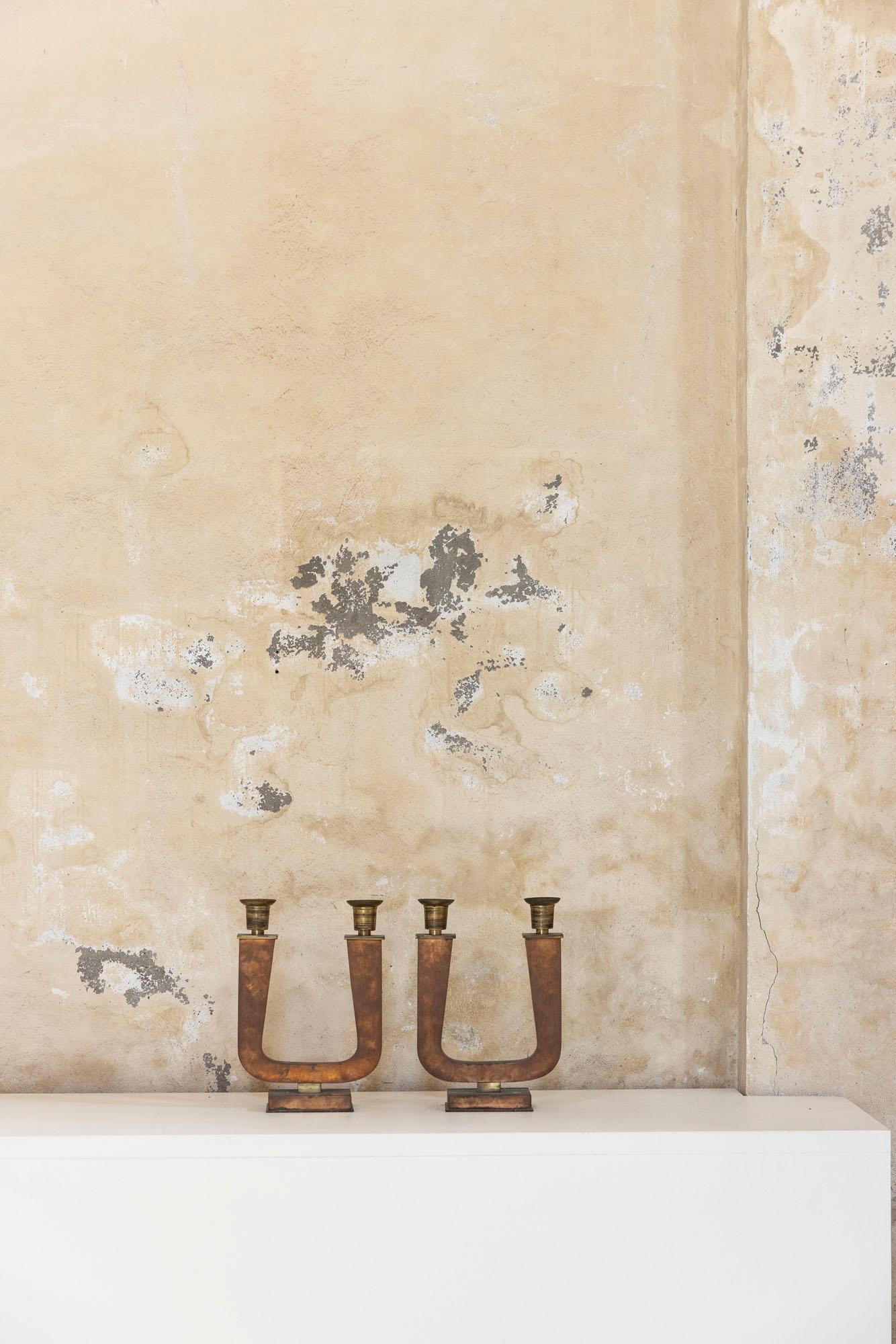 Refined pair of Art Deco candelabra, each featuring two candle arms and a beautifully aged brass structure with gilded brass accents.
The warm vintage patina enhances their sculptural silhouette, making them a striking addition to both classic and