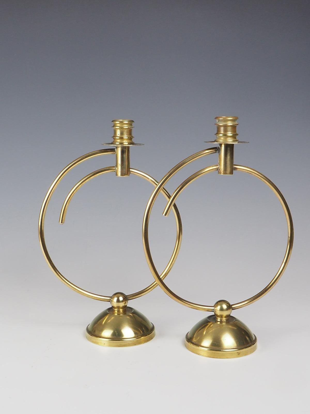 Exquisite pair of Art Deco Brass Candlesticks. Crafted with attention to detail, these candlesticks exude opulence and sophistication. The sleek and slender design features a lustrous brass finish that adds a touch of glamour to any room.

These