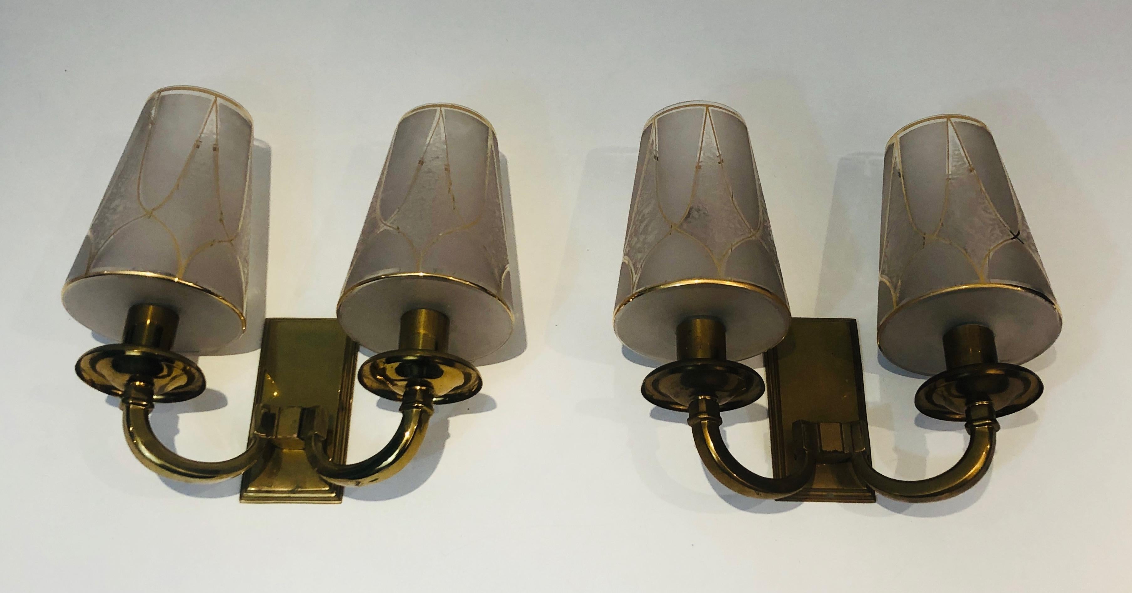 This pair of Art Deco wall lights are made of brass with very nice gilded glass reflectors. This is a French work in the style of Perzel. Circa 1930.