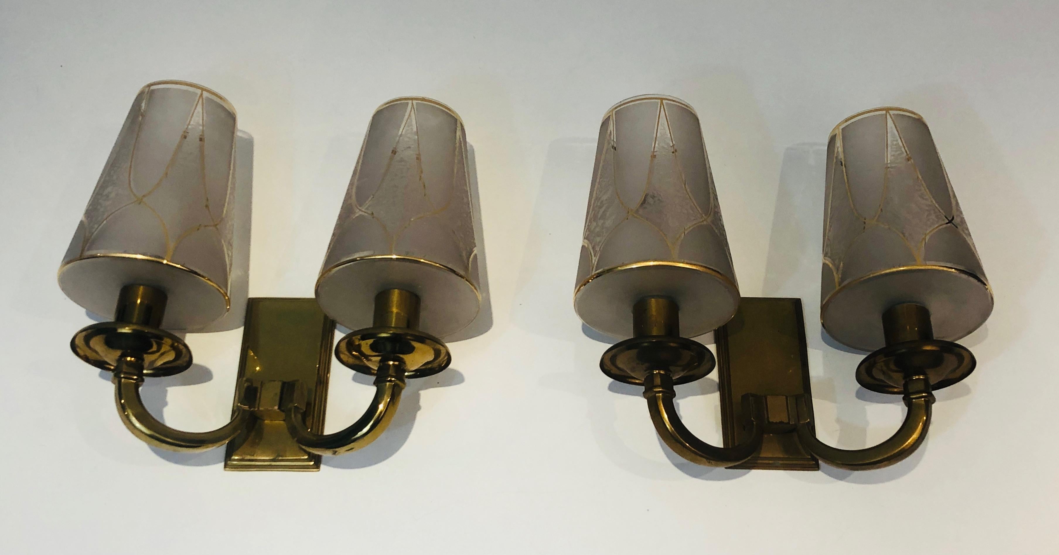 This very nice and unusual pair of Art Deco wall lights is made of brass with very nice gilded glass reflectors. This is a French work in the style of Maison Perzel. Circa 1930.