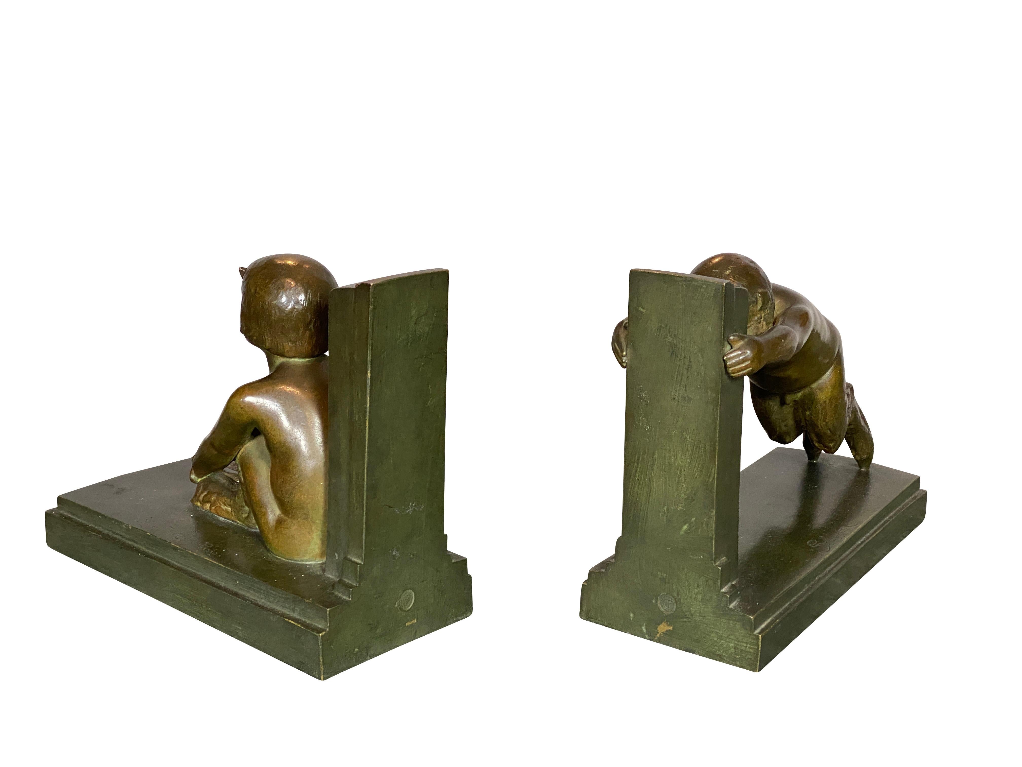 With Susse Freres foundry and signed, depicting a pair of satyr children one sitting and one standing and leaning. Greenish brown patina. Reduced version of the 