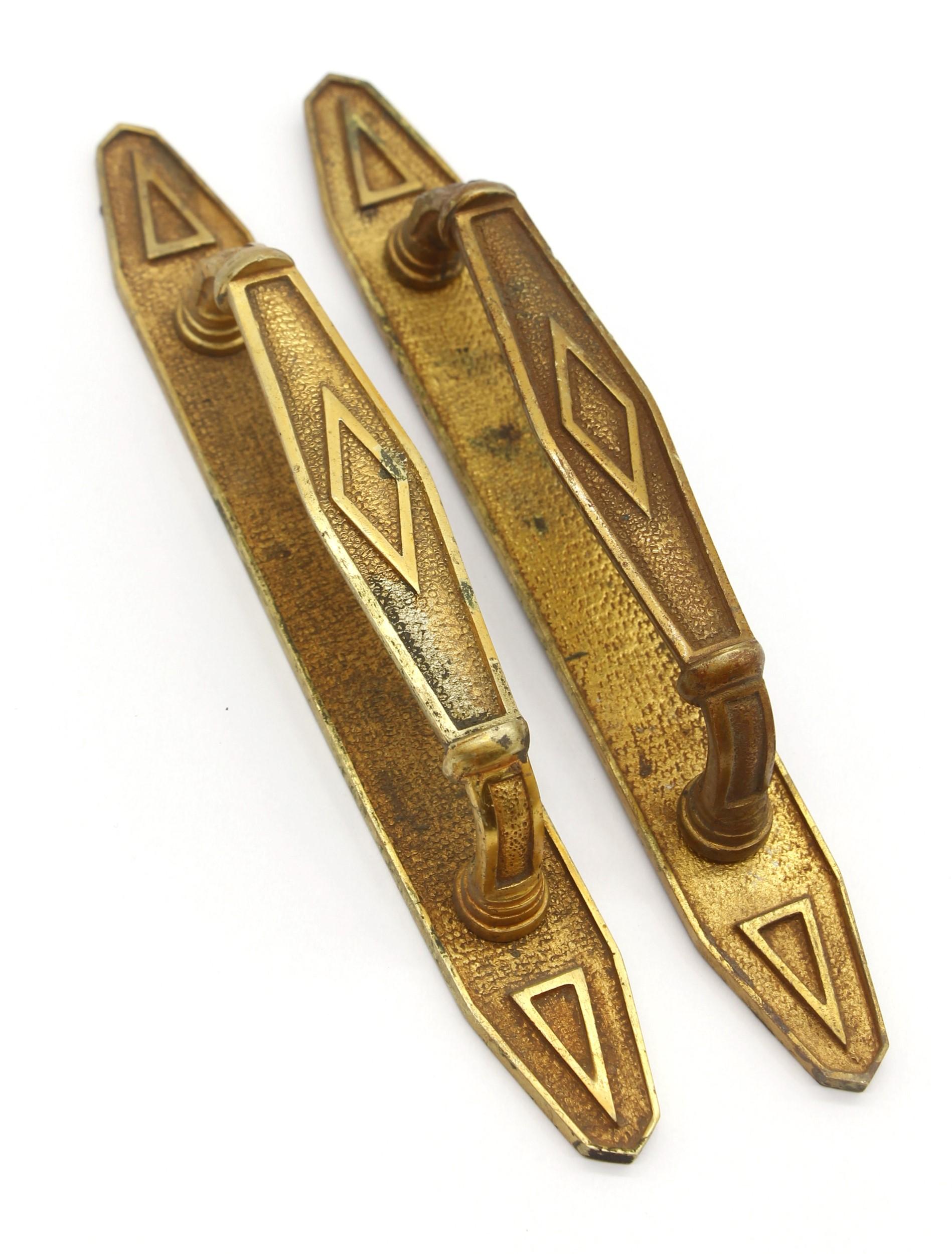This pair of petite bronze Art Deco door pulls were imported from Europe. They feature a geometric design with the original patina. Priced as a pair. This can be seen at our 400 Gilligan St location in Scranton, PA.