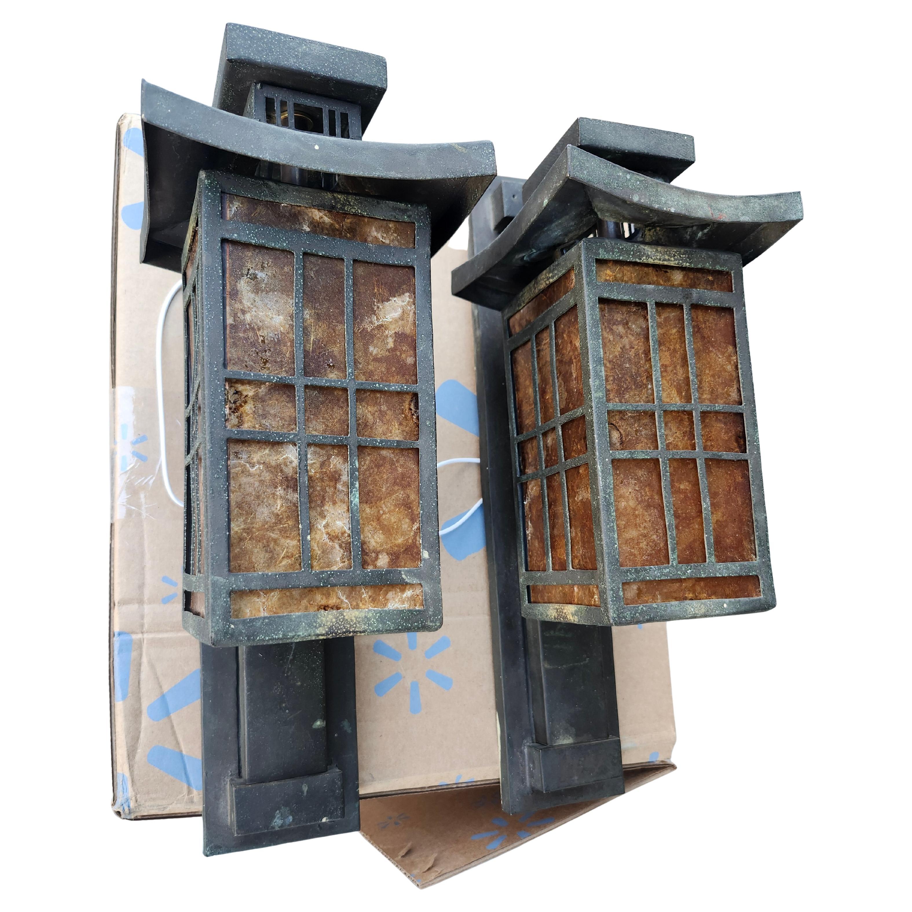 Beautiful pair of handcrafted Art Deco bronze wall mount sconces in a stately pagoda style form. Rewired and fresh new mica panels installed. Bronze has patinated over the years to a dark bronze. All new wiring and sockets, ready to be hung. Priced