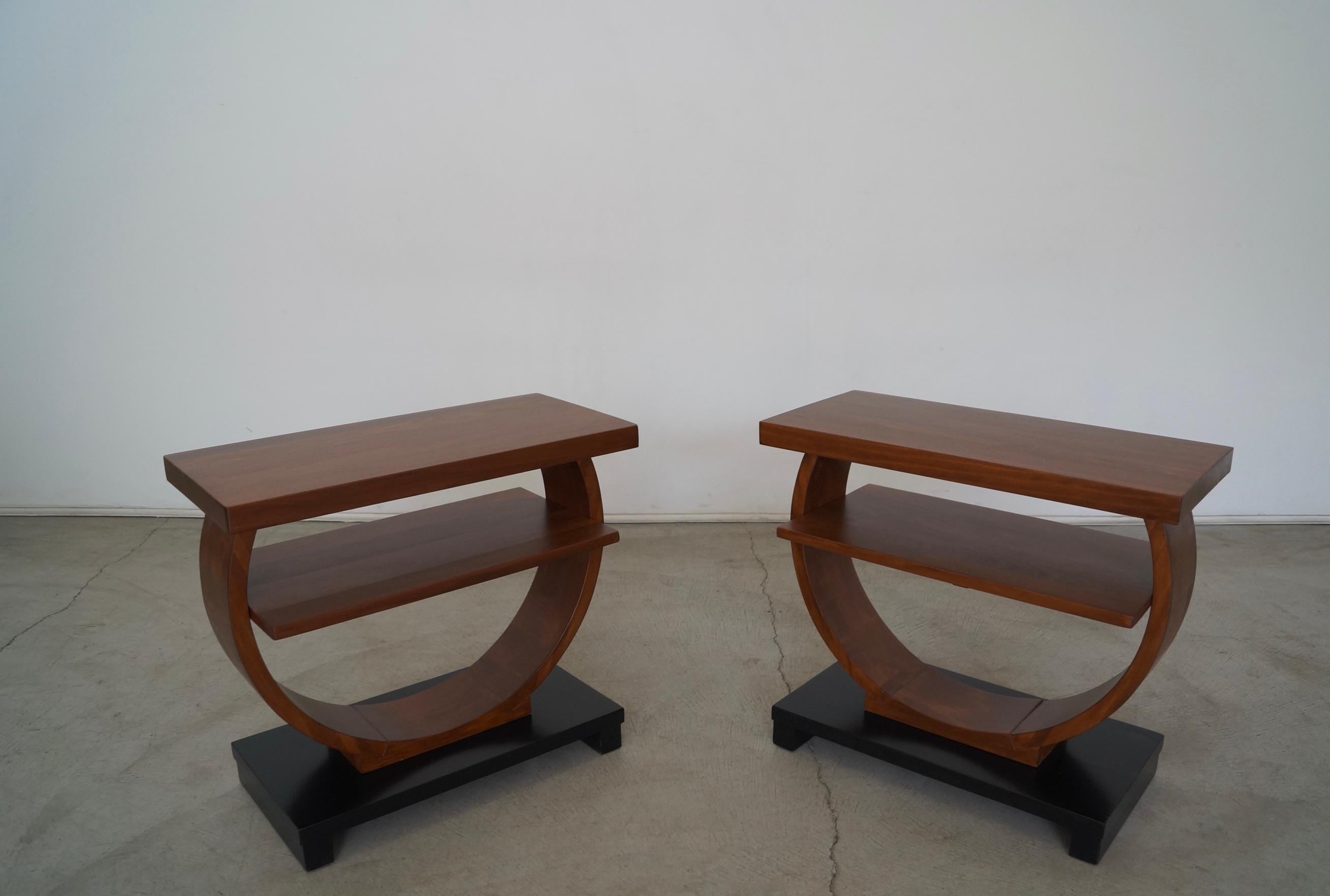 Vintage pair of original Art Deco side tables for sale. Made in the late 1930's, and really solid and well made. These are made of solid wood with no veneer or particle wood. They have been professionally refinished in a walnut finish with a black