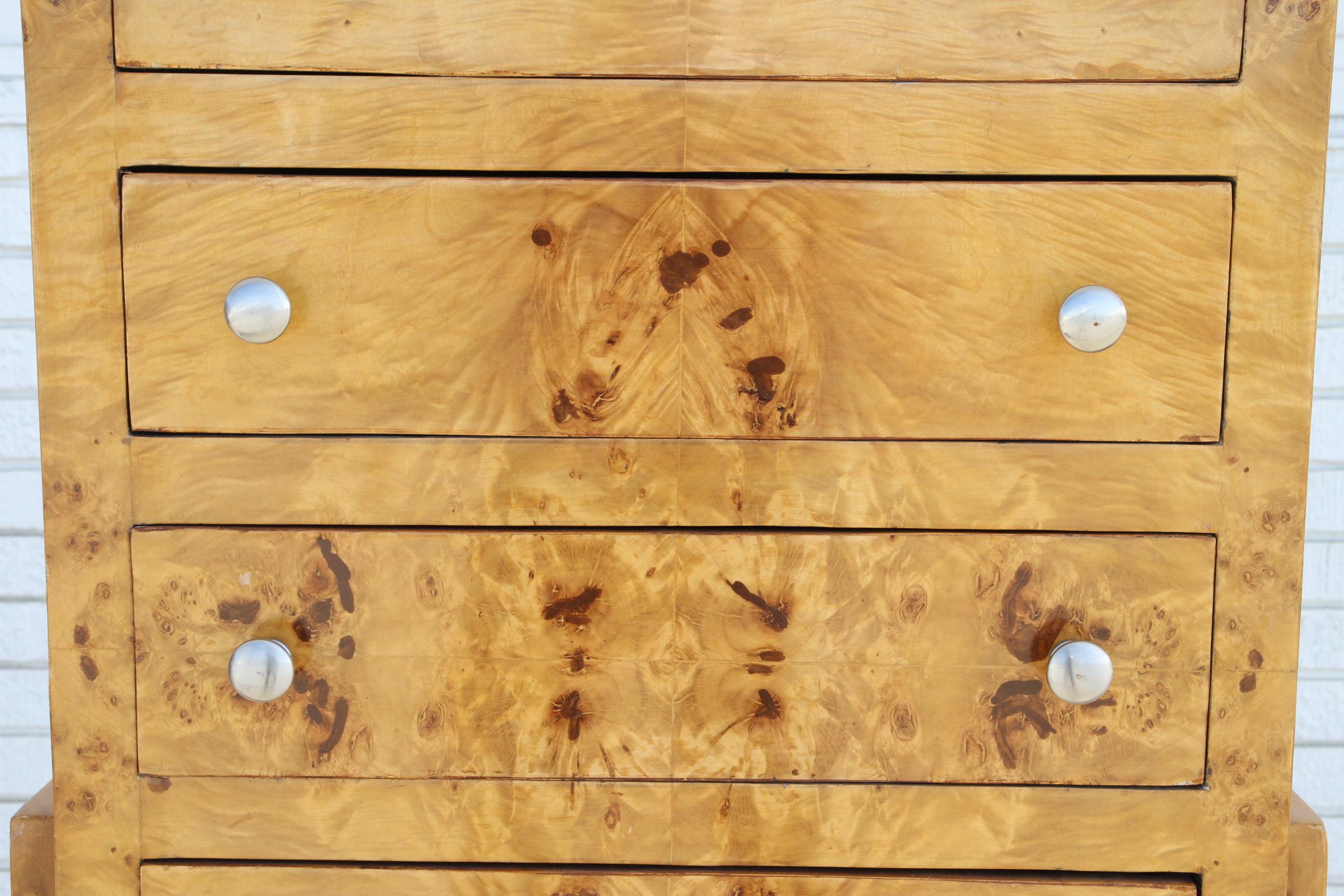 This is a pair of beautiful burl wood Art Deco chest. They are sculptural and highly lacquered to accentuate the beautiful burl of the wood. They have 5 drawers for lots of storage. They rest on a bentwood legs that interlock into the base.

A