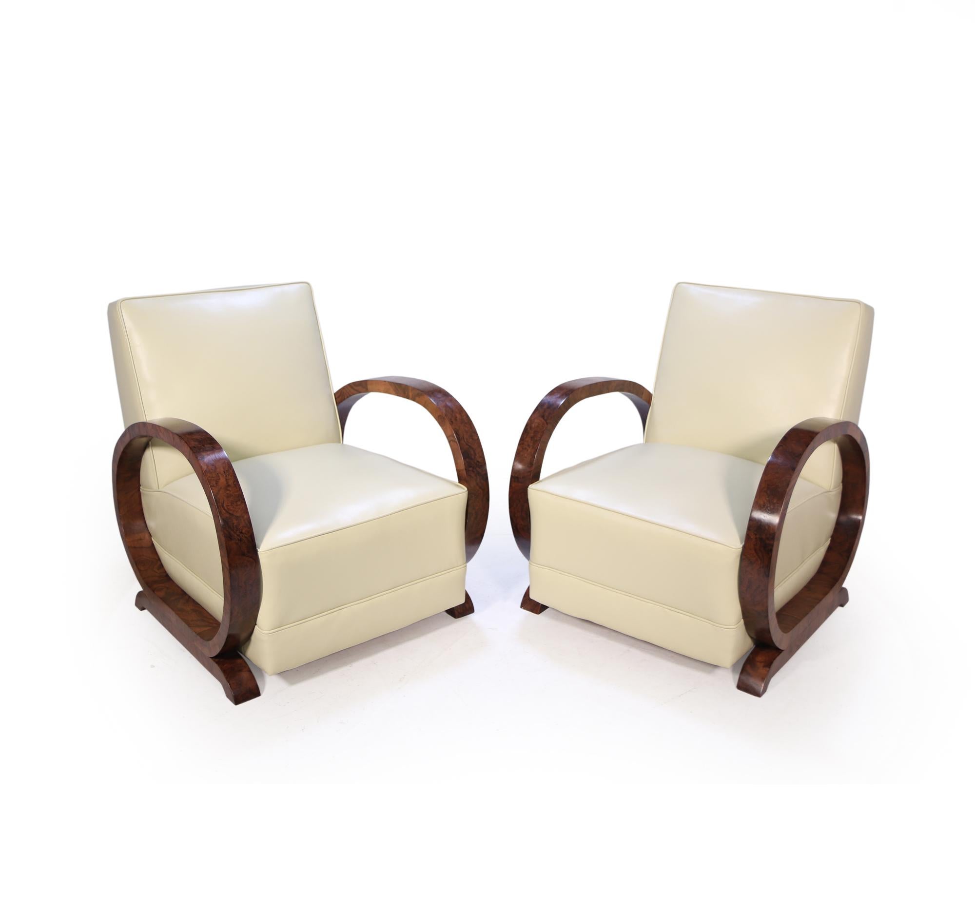 A pair of Italian Art Deco Burr walnut hoop armchairs with coil sprung seat and back re upholstered in thick leather hyde upholstery the chairs are in excellent condition throughout and show wood has been professionally polished

Age: