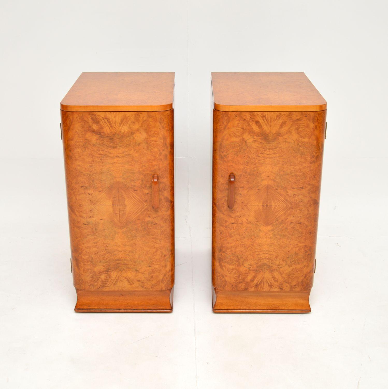 A stylish and extremely well made pair of Art Deco burr walnut bedside cabinets. They were made in England, they date from the 1920-30’s.

The quality is outstanding, they have stunning burr walnut grain patterns, beautifully sculpted handles and