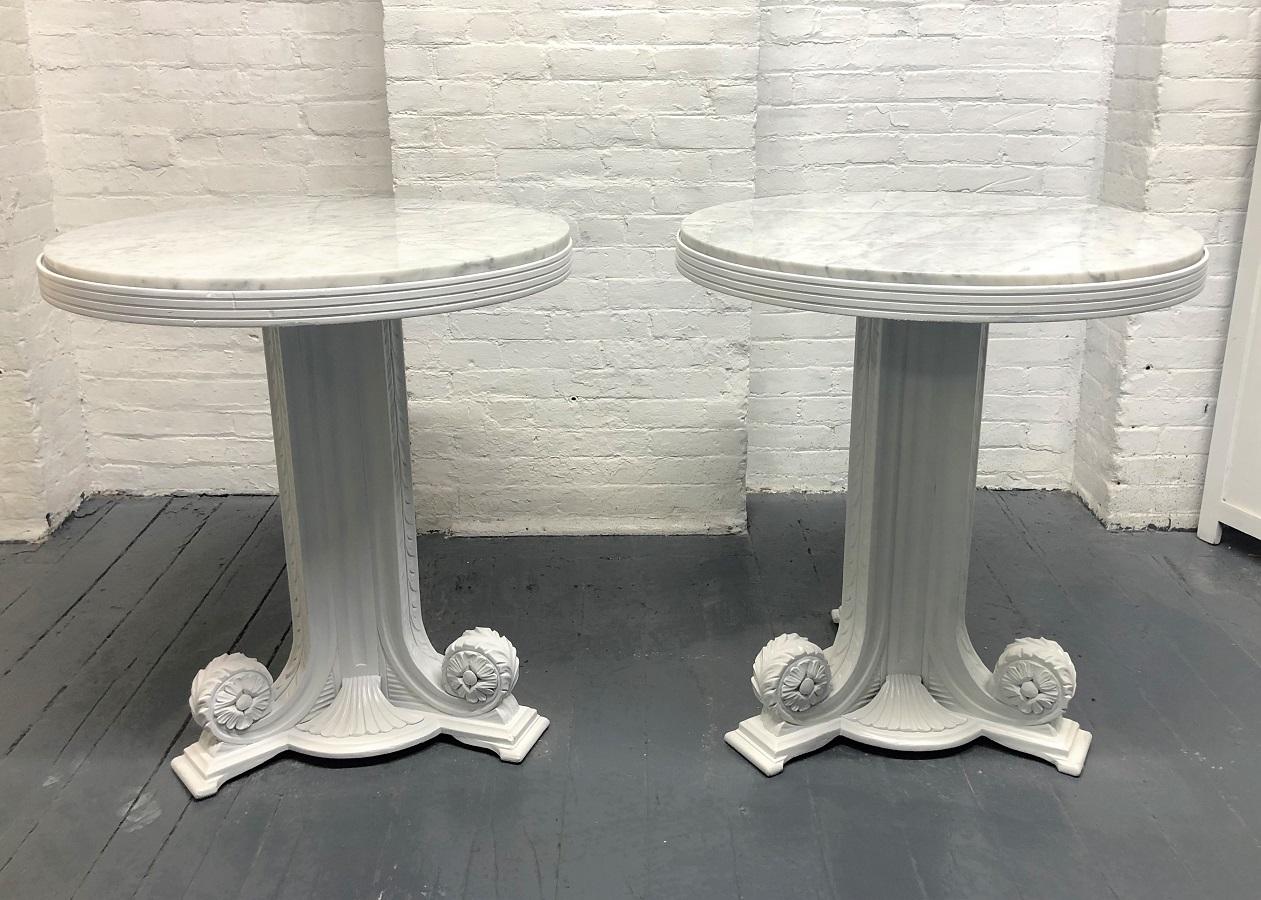 Pair of 1940s Art Deco, Carrara marble pedestal tables. The tables have solid wooden white lacquered decorative frames.
