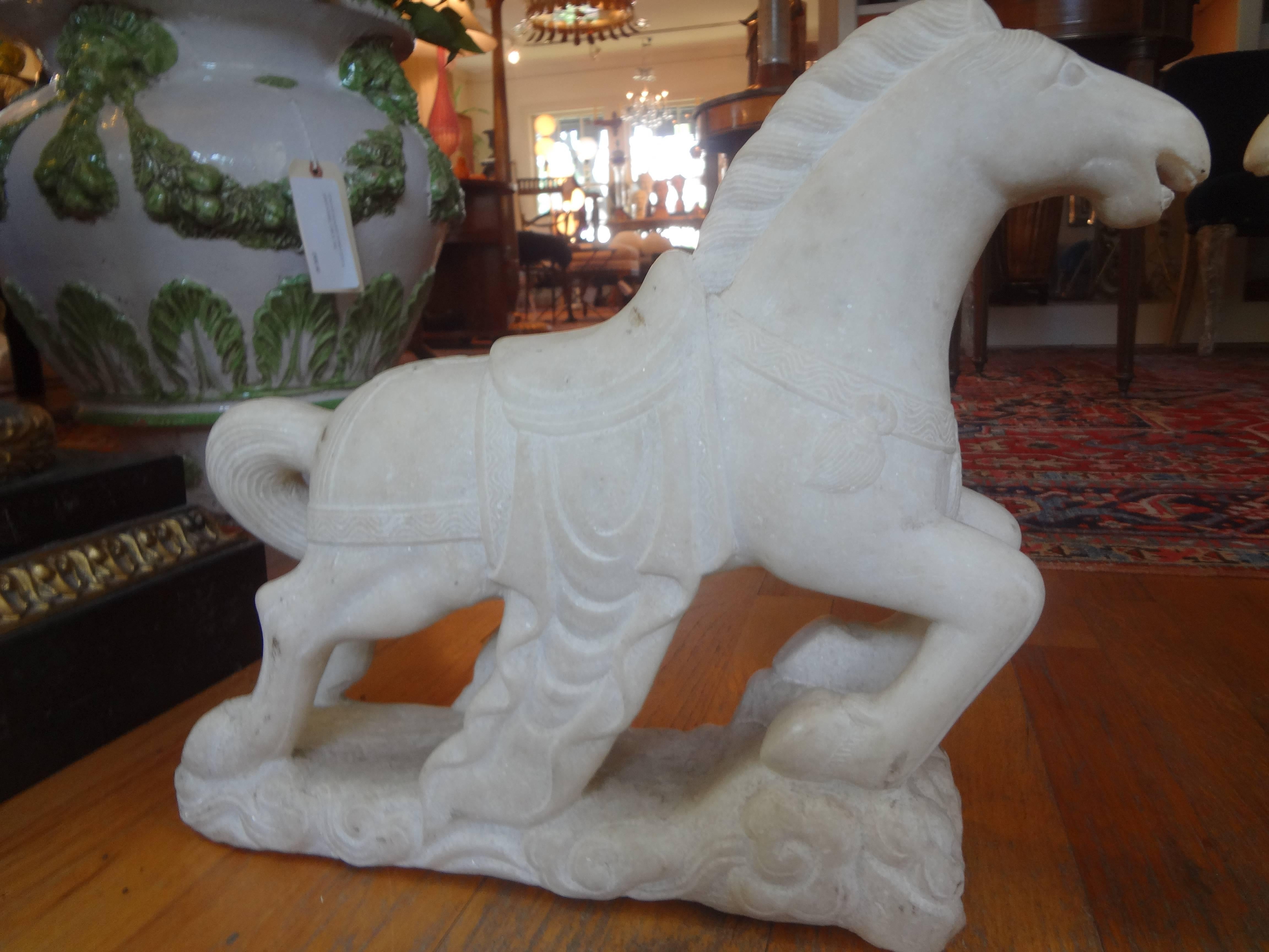 Pair of carved marble horses, circa 1920. This matched pair of marble horse sculptures are very well executed and have a great stylized Art Deco design.