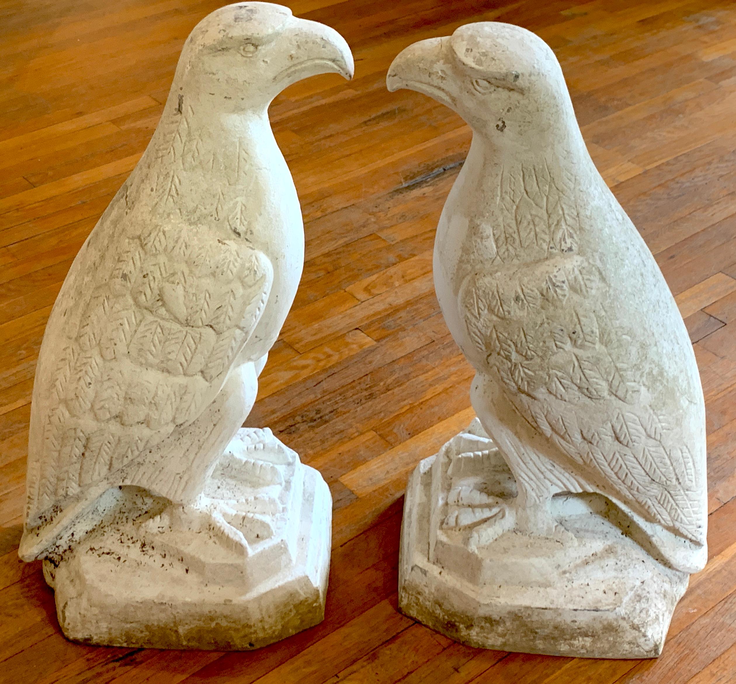 Pair of Art Deco cast aluminum seated garden eagles, each one a finely cast model of a seated eagle on plinth, retains old paint, beautiful patina.
The base measures 17