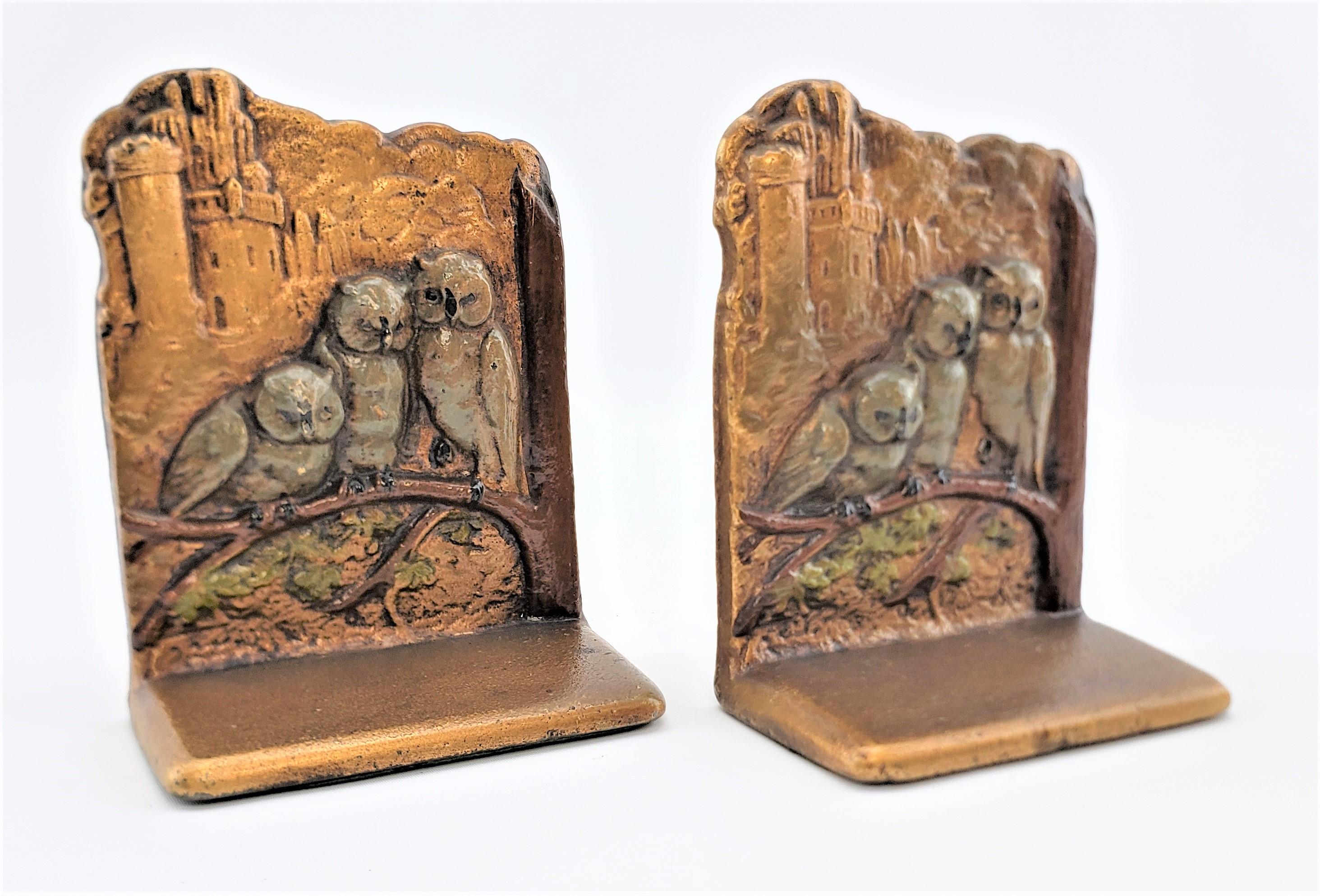 This pair of Art Deco cast brass and cold-painted bookends are signed by an unknown maker, but presumed to have been made in the United States in approximately 1925. The front faces of the bookends were cast with raised owls on branches that have